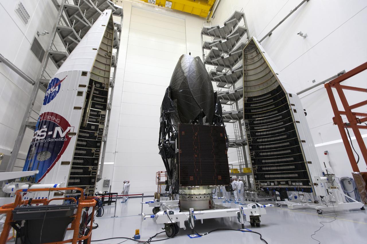 Inside the Astrotech facility in Titusville, Florida, the payload fairing for NASA's Tracking and Data Relay Satellite, TDRS-M, is moved into position to encapsulate the spacecraft. TDRS-M is the latest spacecraft destined for the agency's constellation of communications satellites that allows nearly continuous contact with orbiting spacecraft ranging from the International Space Station and Hubble Space Telescope to the array of scientific observatories. Liftoff atop a United Launch Alliance Atlas V rocket is scheduled to take place from Space Launch Complex 41 at Cape Canaveral Air Force Station at 8:03 a.m. EDT Aug. 18, 2017.