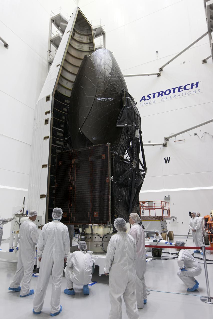 Inside the Astrotech facility in Titusville, Florida, technicians and engineers monitor progress as the payload fairing for NASA's Tracking and Data Relay Satellite, TDRS-M, is moved into position to encapsulate the spacecraft. TDRS-M is the latest spacecraft destined for the agency's constellation of communications satellites that allows nearly continuous contact with orbiting spacecraft ranging from the International Space Station and Hubble Space Telescope to the array of scientific observatories. Liftoff atop a United Launch Alliance Atlas V rocket is scheduled to take place from Space Launch Complex 41 at Cape Canaveral Air Force Station at 8:03 a.m. EDT Aug. 18, 2017.