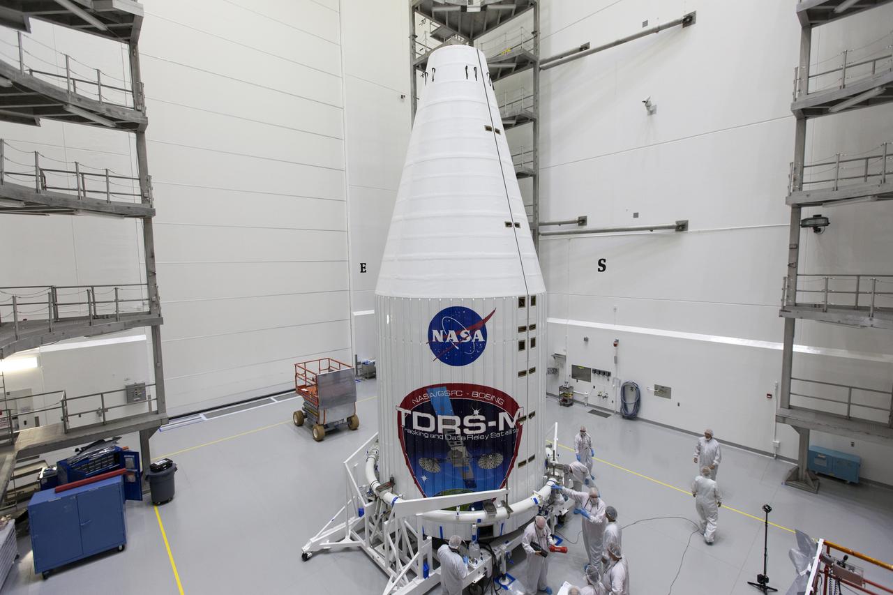 Inside the Astrotech facility in Titusville, Florida, technicians and engineers inspect the NASA's Tracking and Data Relay Satellite, TDRS-M, after it was encapsulated in its payload fairing. TDRS-M is the latest spacecraft destined for the agency's constellation of communications satellites that allows nearly continuous contact with orbiting spacecraft ranging from the International Space Station and Hubble Space Telescope to the array of scientific observatories. Liftoff atop a United Launch Alliance Atlas V rocket is scheduled to take place from Space Launch Complex 41 at Cape Canaveral Air Force Station at 8:03 a.m. EDT Aug. 18, 2017.