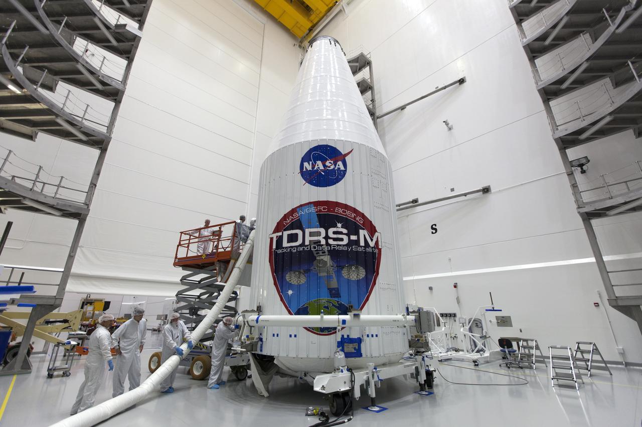 Inside the Astrotech facility near NASA's Kennedy Space Center in Florida, the agency's TDRS-M satellite, enclosed in its payload fairing, is being prepared for lifting to a transport vehicle. The TDRS-M is the latest spacecraft destined for the agency's constellation of communications satellites that allows nearly continuous contact with orbiting spacecraft ranging from the International Space Station and Hubble Space Telescope to the array of scientific observatories. Liftoff atop a United Launch Alliance Atlas V rocket is scheduled to take place from Space Launch Complex 41 at Cape Canaveral Air Force Station on Aug. 18 at 8:03 a.m. EDT.