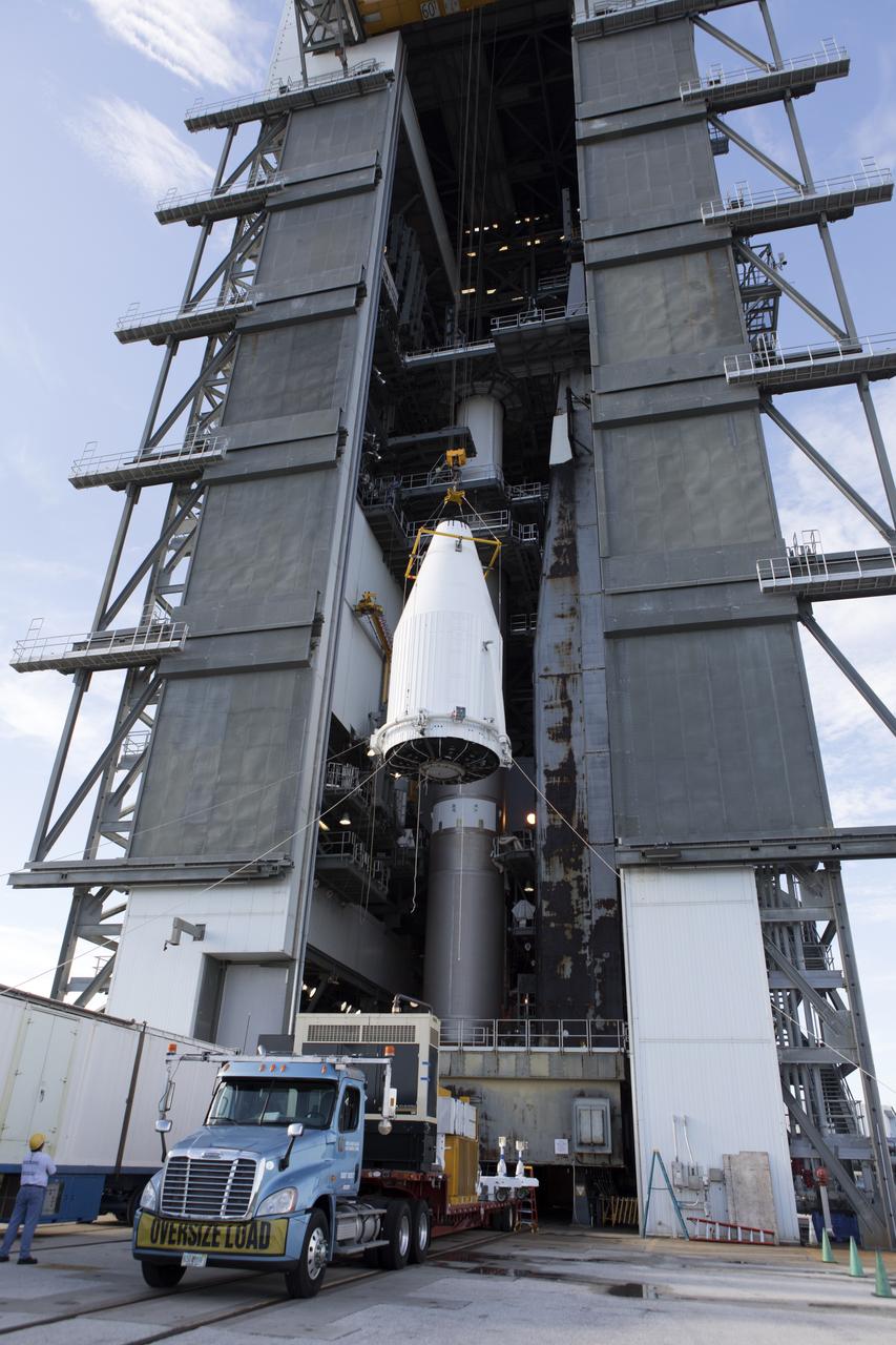A crane is used to lift the payload fairing containing NASA's Tracking and Data Relay Satellite (TDRS-M) at the Vertical Integration Facility at Space Launch Complex 41 at Cape Canaveral Air Force Station in Florida. TDRS-M will be stacked atop the United Launch Alliance Atlas V Centaur upper stage. TDRS-M will be the latest spacecraft destined for the agency's constellation of communications satellites that allows nearly continuous contact with orbiting spacecraft ranging from the International Space Station and Hubble Space Telescope to the array of scientific observatories. Liftoff atop the ULA Atlas V rocket is scheduled for Aug. 18, 2017.