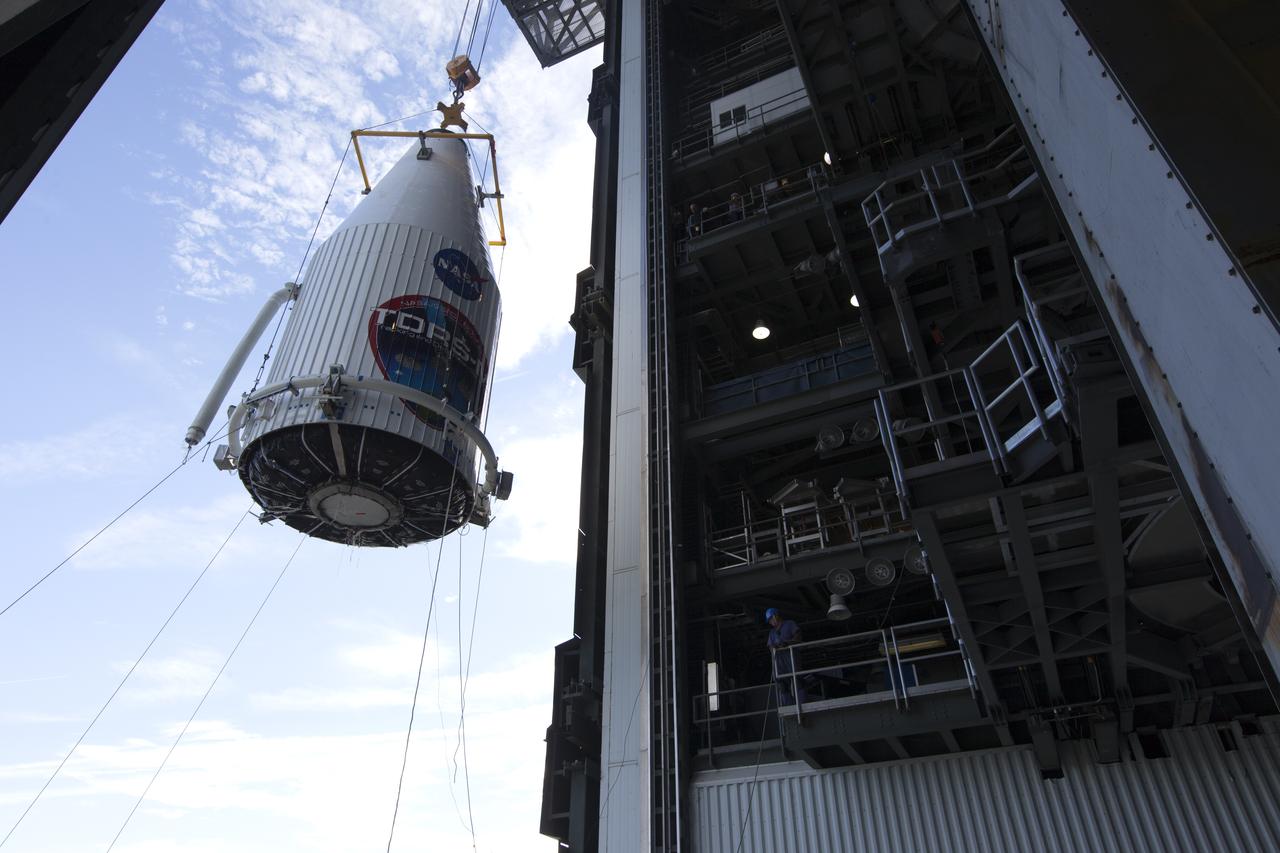 A crane is used to lift the payload fairing containing NASA's Tracking and Data Relay Satellite (TDRS-M) at the Vertical Integration Facility at Space Launch Complex 41 at Cape Canaveral Air Force Station in Florida. TDRS-M will be stacked atop the United Launch Alliance Atlas V Centaur upper stage. TDRS-M will be the latest spacecraft destined for the agency's constellation of communications satellites that allows nearly continuous contact with orbiting spacecraft ranging from the International Space Station and Hubble Space Telescope to the array of scientific observatories. Liftoff atop the ULA Atlas V rocket is scheduled for Aug. 18, 2017.
