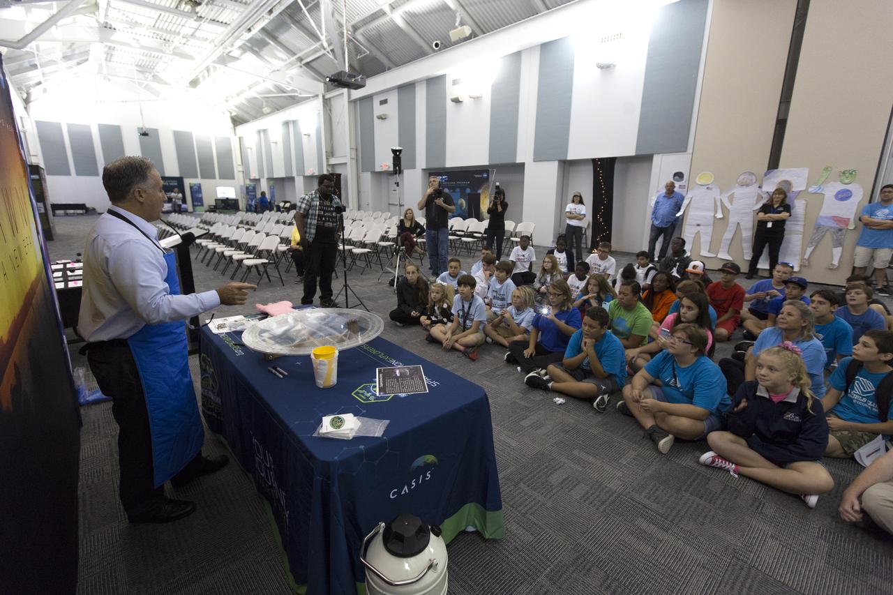 NASA Kennedy Space Center's Trent Smith conducts a quantum levitation demonstration, using liquid nitrogen, metal and a magnetic track, for students and their sponsors in the Center for Space Education at NASA’s Kennedy Space Center in Florida. Teams from across the state of Florida were gathered at Kennedy for the finals of the Zero Robotics Middle School Summer Program national championship. The five-week program allows rising sixth- through ninth-graders to write programs for small satellites called SPHERES (Synchronized, Position, Hold, Engage, Reorient, Experimental Satellites). Finalists saw their code tested aboard the International Space Station.