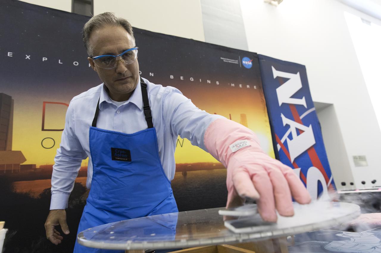 NASA Kennedy Space Center's Trent Smith conducts a quantum levitation demonstration, using liquid nitrogen, metal and a magnetic track, for students and their sponsors in the Center for Space Education at NASA’s Kennedy Space Center in Florida. Teams from across the state of Florida were gathered at Kennedy for the finals of the Zero Robotics Middle School Summer Program national championship. The five-week program allows rising sixth- through ninth-graders to write programs for small satellites called SPHERES (Synchronized, Position, Hold, Engage, Reorient, Experimental Satellites). Finalists saw their code tested aboard the International Space Station.