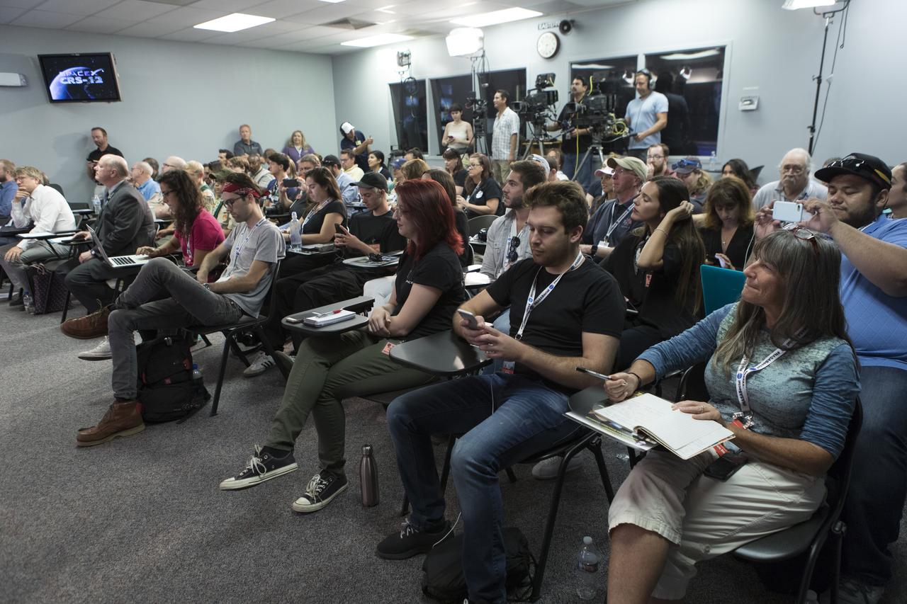 In the Kennedy Space Center’s Press Site auditorium, members of social media listen to a briefing focused on research planned for launch to the International Space Station. The scientific materials and supplies will be aboard a Dragon spacecraft scheduled for launch from Kennedy’s Launch Complex 39A on Aug. 14 atop a SpaceX Falcon 9 rocket on the company's 12th Commercial Resupply Services mission to the space station.
