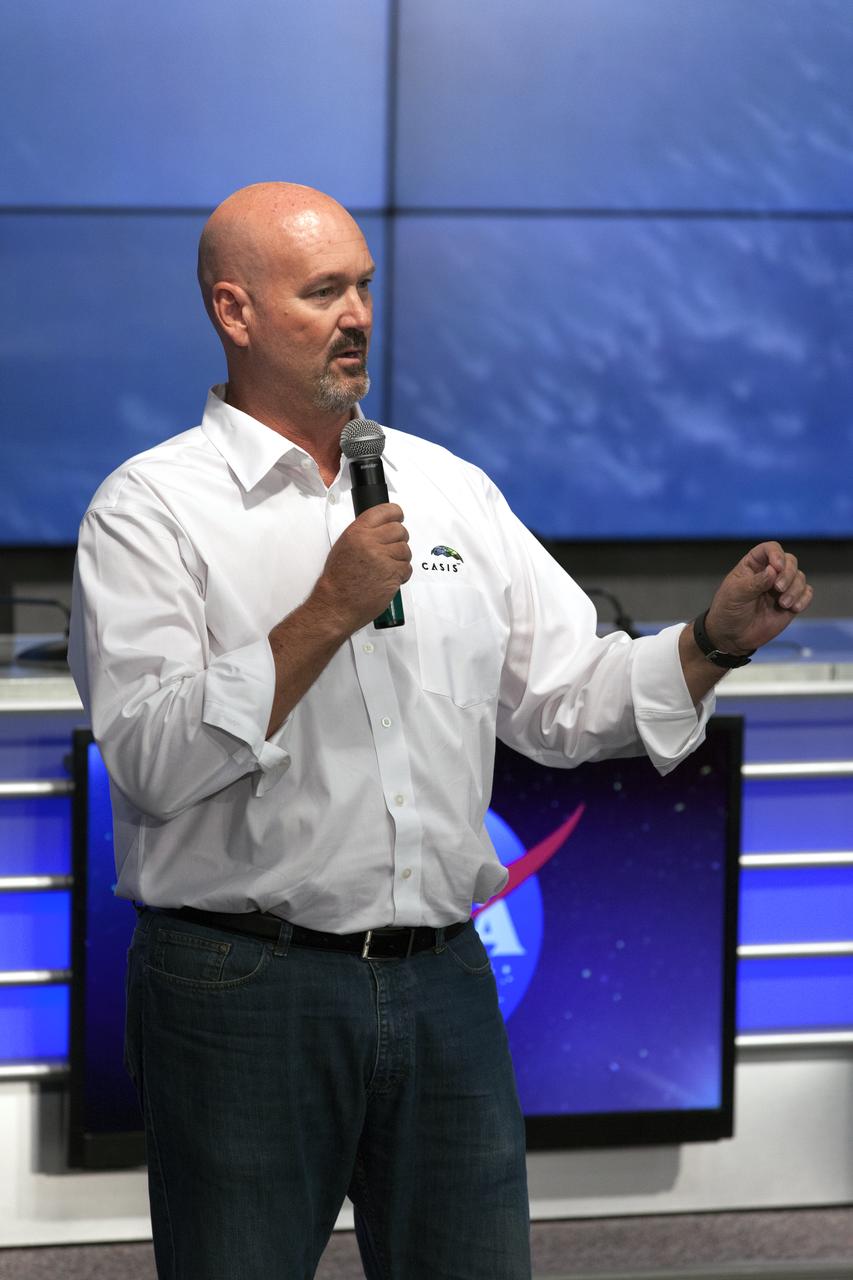 Ken Shields, director of Operations for Center for the Advancement of Science in Space/ISS National Lab, speaks to members of social media in the Kennedy Space Center’s Press Site auditorium. The briefing focused on research planned for launch to the International Space Station. The scientific materials and supplies will be aboard a Dragon spacecraft scheduled for launch from Kennedy’s Launch Complex 39A on Aug. 14 atop a SpaceX Falcon 9 rocket on the company's 12th Commercial Resupply Services mission to the space station.