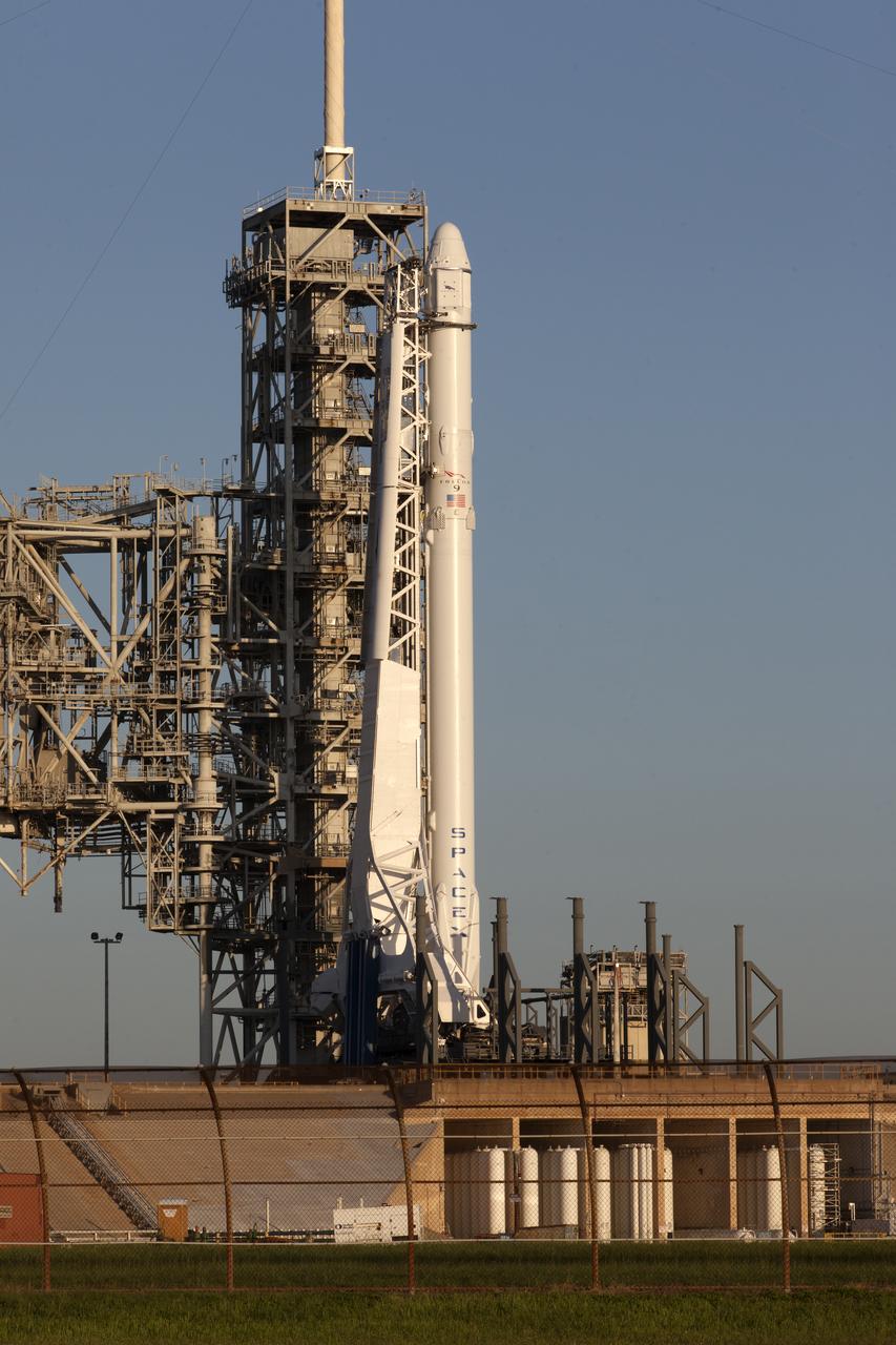 As a Falcon 9 rocket stands ready for liftoff at the Kennedy Space Center's Launch Complex 39A. The rocket will boost a Dragon resupply spacecraft to the International Space Station. Liftoff is scheduled for 12:31 p.m. EDT. On its 12th commercial resupply services mission to the space station, Dragon will bring up more than 6,400 pounds of supplies. The historic launch site now is operated by SpaceX under a property agreement signed with NASA.