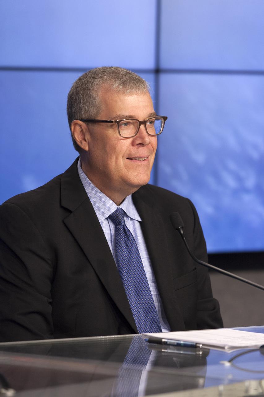In the Press Site auditorium of NASA's Kennedy Space Center in Florida, Dan Hartman, NASA deputy manager of the International Space Station Program, speaks to media at a post-launch news conference following the liftoff of SpaceX CRS-12, a commercial resupply services mission to the International Space Station. SpaceX CRS-12 lifted off atop a Falcon 9 rocket from Kennedy's Launch Complex 39A at 12:31 p.m. EDT.