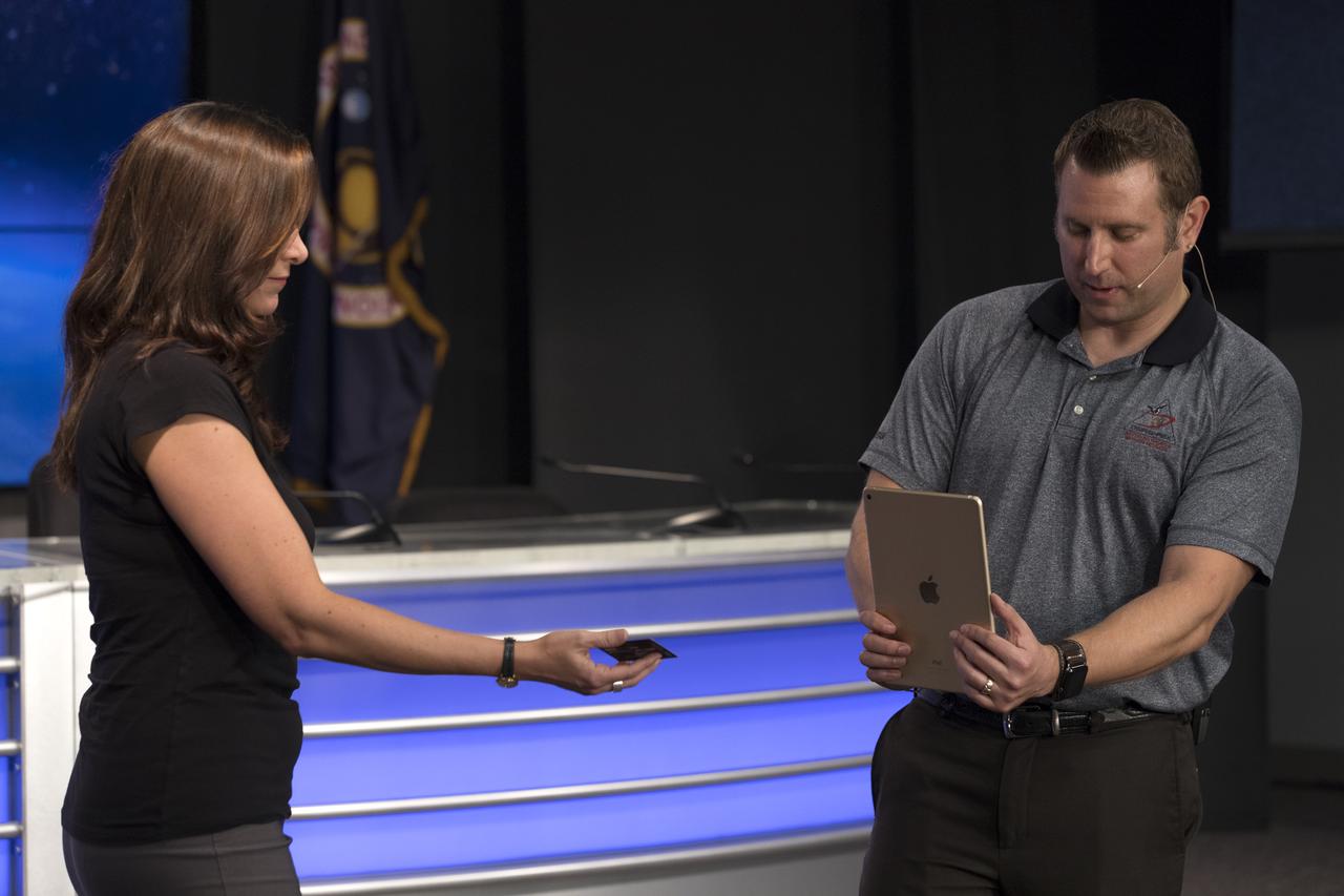 Skip Owen of NASA Launch Services, right, is demonstrating an app that can run on a mobile device such as a smartphone or tablet computer. The app is depicting the launch of the TDRS-M satellite on an Atlas V rocket. The demonstration took place during a briefing focused on preparations to launch NASA's Tracking and Data Relay Satellite, TDRS-M. The latest spacecraft destined for the agency's constellation of communications satellites, TDRS-M will allow nearly continuous contact with orbiting spacecraft ranging from the International Space Station and Hubble Space Telescope to the array of scientific observatories. Liftoff atop a United Launch Alliance Atlas V rocket is scheduled to take place from Space Launch Complex 41 at Cape Canaveral Air Force Station at 8:03 a.m. EDT Aug. 18.