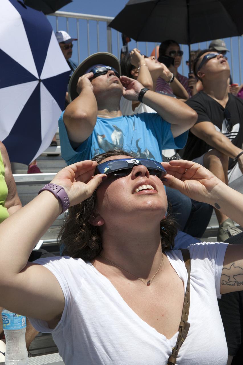 From the Kennedy Space Center Visitor Complex, guests joined Americans from coast to coast following the solar eclipse. Although a partial eclipse on Florida's Space Coast, young and old alike found many ways to watch the rare astronomical event. As the Moon passed between Earth and the midafternoon Sun, a shadow moved across the landscape. The 70-mile-wide totality path, or "umbral cone" -- where the entire Sun will vanish behind the Moon -- stretched across 14 states, from Oregon to South Carolina.
