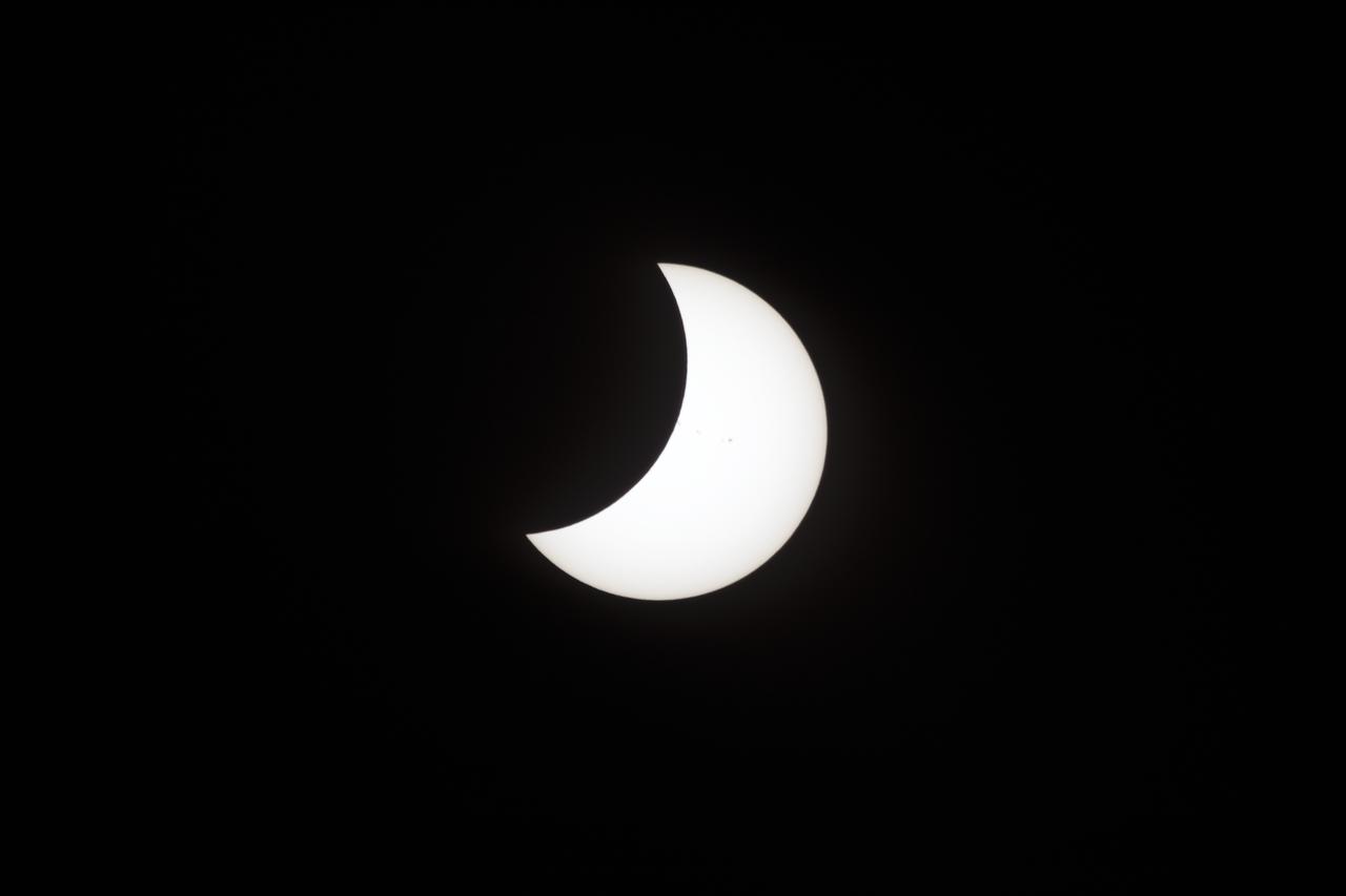 A partial eclipse on Florida's Space Coast, the rare astronomical event was photographed from the top of the Vehicle Assembly Building, as the Moon passed between Earth and the midafternoon Sun. The Moon's shadow moved across the landscape from Oregon to South Carolina. The 70-mile-wide totality path, or "umbral cone" -- where the entire Sun will vanish behind the Moon -- stretched across 14 states, from Oregon to South Carolina.
