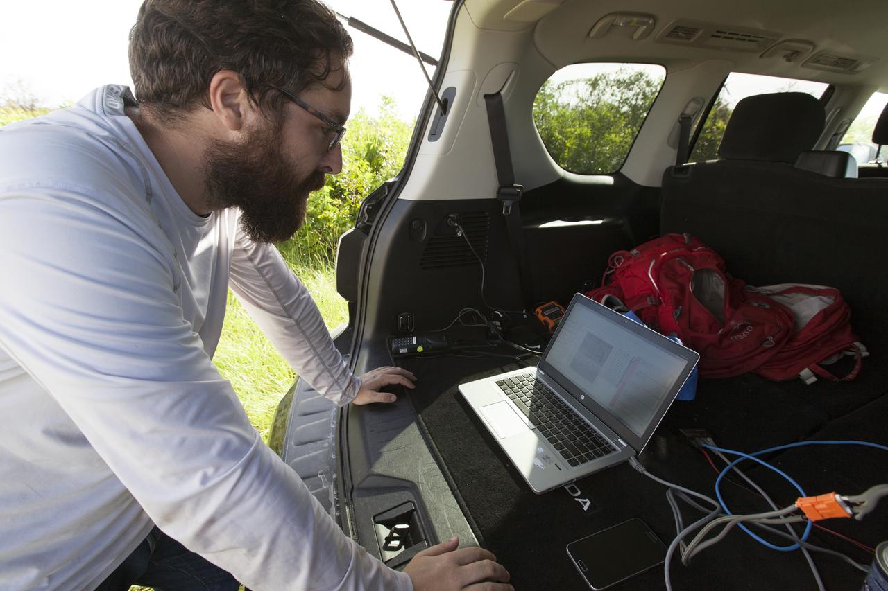 An engineer checks readings from microphone arrays that were strategically positioned along the ground at NASA's Kennedy Space Center in Florida to collect sound signatures from sonic booms created by agency F-18 jets flying faster than the speed of sound. Several flights a day have been taking place the week of Aug. 21, 2017 as part of NASA's Sonic Booms in Atmospheric Turbulence, or SonicBAT II Program. NASA at Kennedy is partnering with the agency's Armstrong Flight Research Center in California, Langley Research Center in Virginia, and Space Florida for a program in which F-18 jets will take off from the Shuttle Landing Facility and fly at supersonic speeds while agency researchers measure the effects of low-altitude turbulence caused by sonic booms.