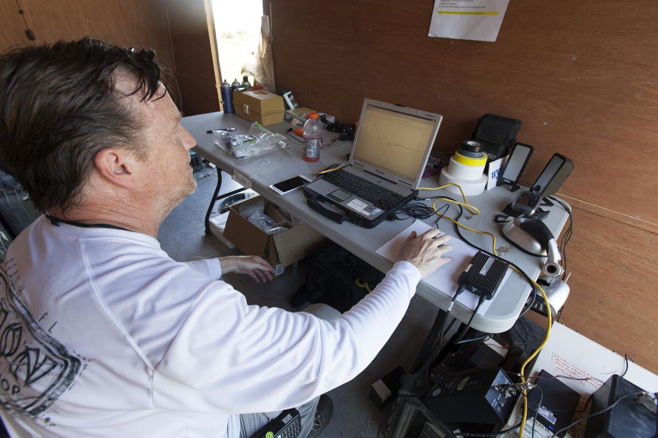 An engineer in a control trailer at NASA's Kennedy Space Center in Florida monitors data before flights of agency F-18 jets to measure the effects of sonic booms. Several flights a day have been taking place the week of Aug. 21, 2017 as part of NASA's Sonic Booms in Atmospheric Turbulence, or SonicBAT II Program. NASA at Kennedy is partnering with the agency's Armstrong Flight Research Center in California, Langley Research Center in Virginia, and Space Florida for a program in which F-18 jets will take off from the Shuttle Landing Facility and fly at supersonic speeds while agency researchers measure the effects of low-altitude turbulence caused by sonic booms.