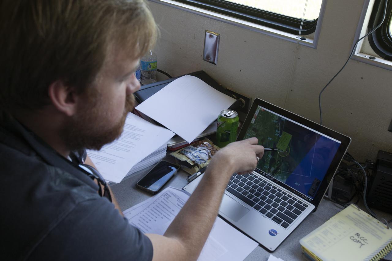 An engineer in a control trailer at NASA's Kennedy Space Center in Florida monitors data before flights of agency F-18 jets to measure the effects of sonic booms. Several flights a day have been taking place the week of Aug. 21, 2017 as part of NASA's Sonic Booms in Atmospheric Turbulence, or SonicBAT II Program. NASA at Kennedy is partnering with the agency's Armstrong Flight Research Center in California, Langley Research Center in Virginia, and Space Florida for a program in which F-18 jets will take off from the Shuttle Landing Facility and fly at supersonic speeds while agency researchers measure the effects of low-altitude turbulence caused by sonic booms.