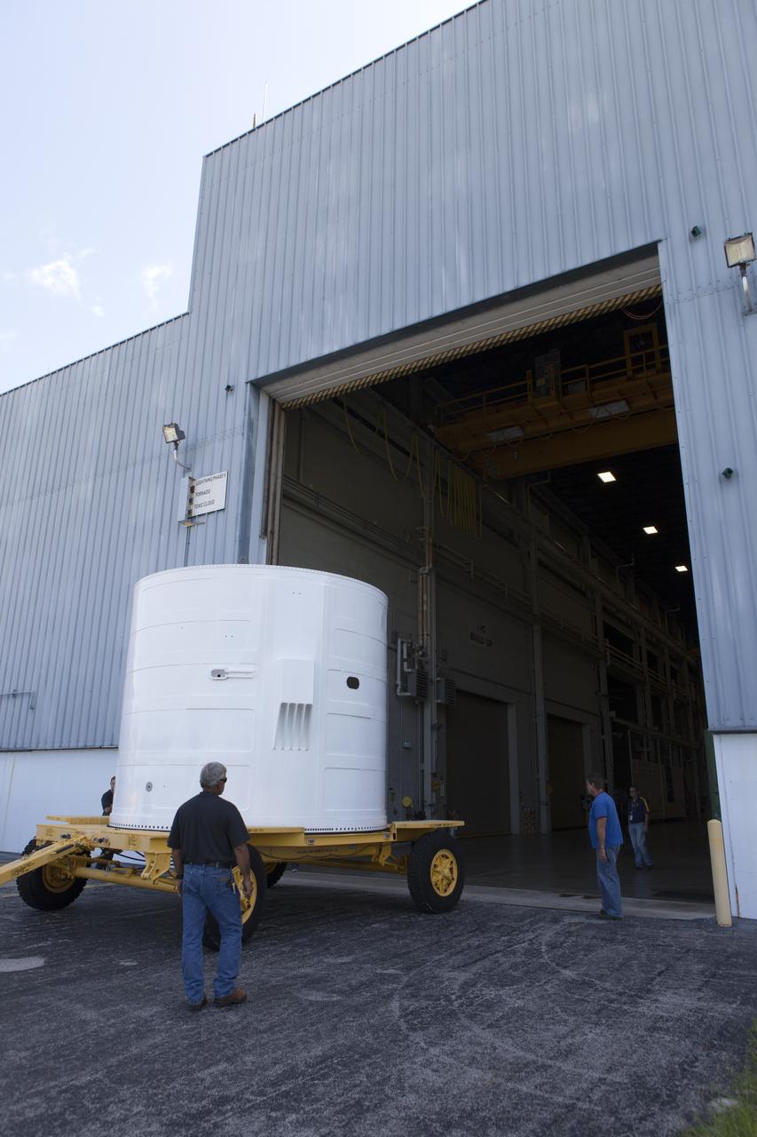 The Exploration Mission-1 (EM-1) left-hand forward skirt for NASA's Space Launch System (SLS) solid rocket boosters arrives at the entrance to the high bay at the Booster Fabrication Facility (BFF) at NASA's Kennedy Space Center in Florida. In the BFF, the forward skirt will be inspected and prepared for use on the left-hand solid rocket booster for EM-1. NASA's Orion spacecraft will fly atop the SLS rocket on its first uncrewed flight test. 