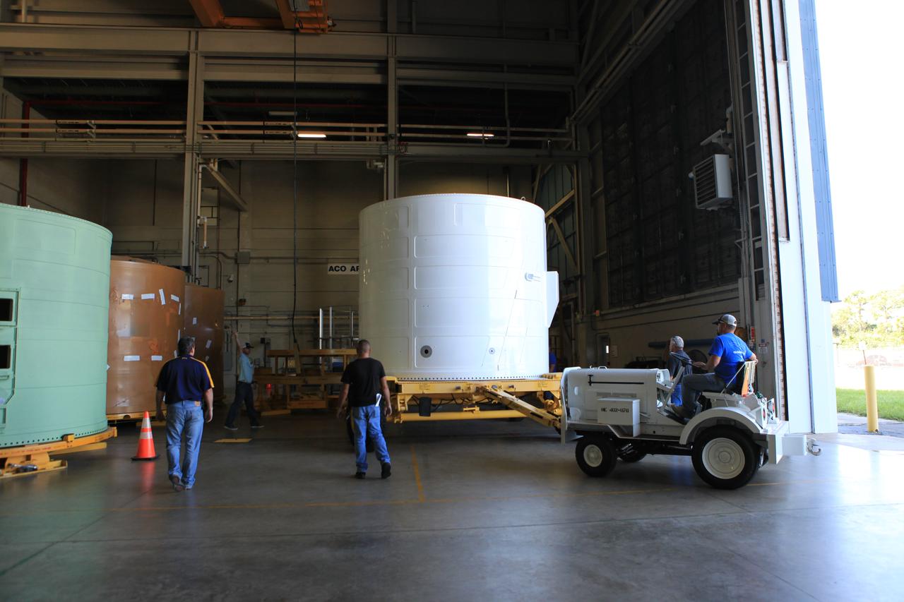 The Exploration Mission-1 (EM-1) left-hand forward skirt for NASA's Space Launch System (SLS) solid rocket boosters arrives inside the high bay at the Booster Fabrication Facility (BFF) at NASA's Kennedy Space Center in Florida. In the BFF, the forward skirt will be inspected and prepared for use on the left-hand solid rocket booster for EM-1. NASA's Orion spacecraft will fly atop the SLS rocket on its first uncrewed flight test.