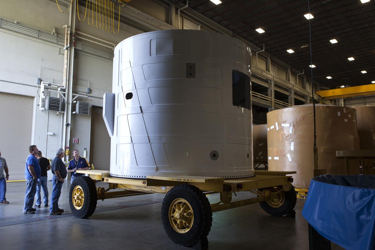 The Exploration Mission-1 (EM-1) left-hand forward skirt for NASA's Space Launch System (SLS) solid rocket boosters arrives inside the high bay at the Booster Fabrication Facility (BFF) at NASA's Kennedy Space Center in Florida. In the BFF, the forward skirt will be inspected and prepared for use on the left-hand solid rocket booster for EM-1. NASA's Orion spacecraft will fly atop the SLS rocket on its first uncrewed flight test. 