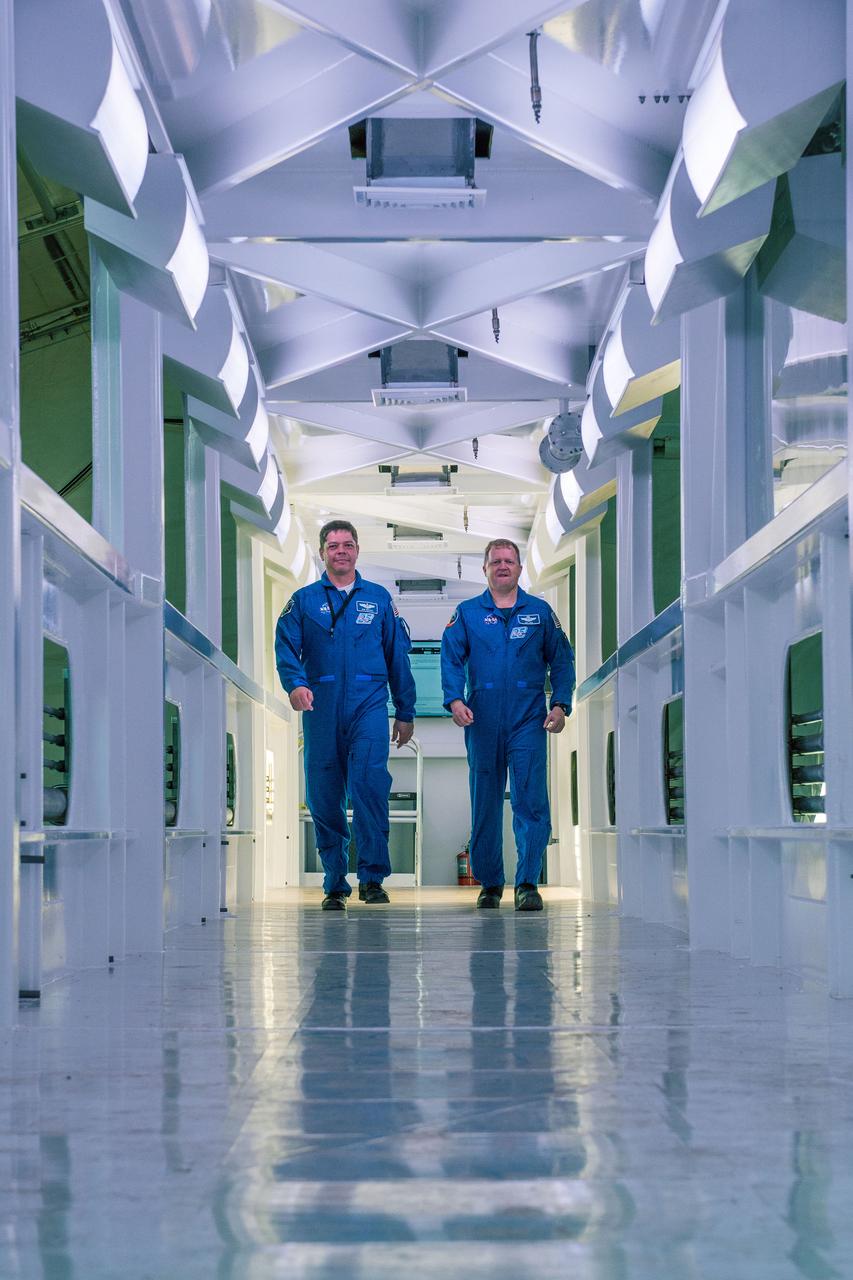 Astronauts Bob Behnken, left, and Eric Boe walk down the Crew Access Arm being built by SpaceX for Launch Complex 39A at NASA’s Kennedy Space Center in Florida. The access arm will be installed on the launch pad, providing a bridge between the launch tower it’s the Fixed Service Structure, as noted below, and SpaceX’s Dragon 2 spacecraft for astronauts flying to the International Space Station on the company’s Falcon 9 rocket as part of NASA’s Commercial Crew Program. The access arm is being readied for installation in early 2018. It will be installed 70 feet higher than the former space shuttle access arm on the launch pad’s Fixed Service Structure. SpaceX continues to modify the historic launch site from its former space shuttle days, removing more than 500,000 pounds of steel from the pad structure, including the Rotating Service Structure that was once used for accessing the payload bay of the shuttle. SpaceX also is using the modernized site to launch commercial payloads, as well as cargo resupply missions to and from the International Space Station for NASA. The first SpaceX launch from the historic Apollo and space shuttle site was this past February. NASA’s Commercial Crew Program is working with private companies, Boeing and SpaceX, with a goal of once again flying people to and from the International Space Station, launching from the United States. 