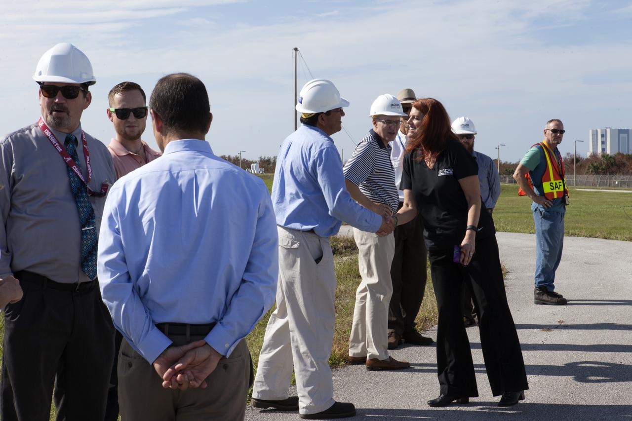 NASA Launch Director Charlie Blackwell-Thompson, at right, greets engineers and technicians at Launch Pad 39B at the agency's Kennedy Space Center in Florida. Blackwell-Thompson will observe the first major tanking operation of liquid oxygen, or LO2, into the giant storage sphere at the northwest corner of the pad to prepare for the launch of the agency's Orion spacecraft atop the Space Launch System (SLS) rocket. During the operation, several Praxair trucks will slowly offload LO2 to gradually chill down the sphere from normal temperature to about negative 298 degrees Fahrenheit. The Ground Systems Development and Operations Program is overseeing upgrades and modifications to pad B to support the launch of the SLS and Orion spacecraft for Exploration Mission-1, deep space missions and NASA’s journey to Mars.