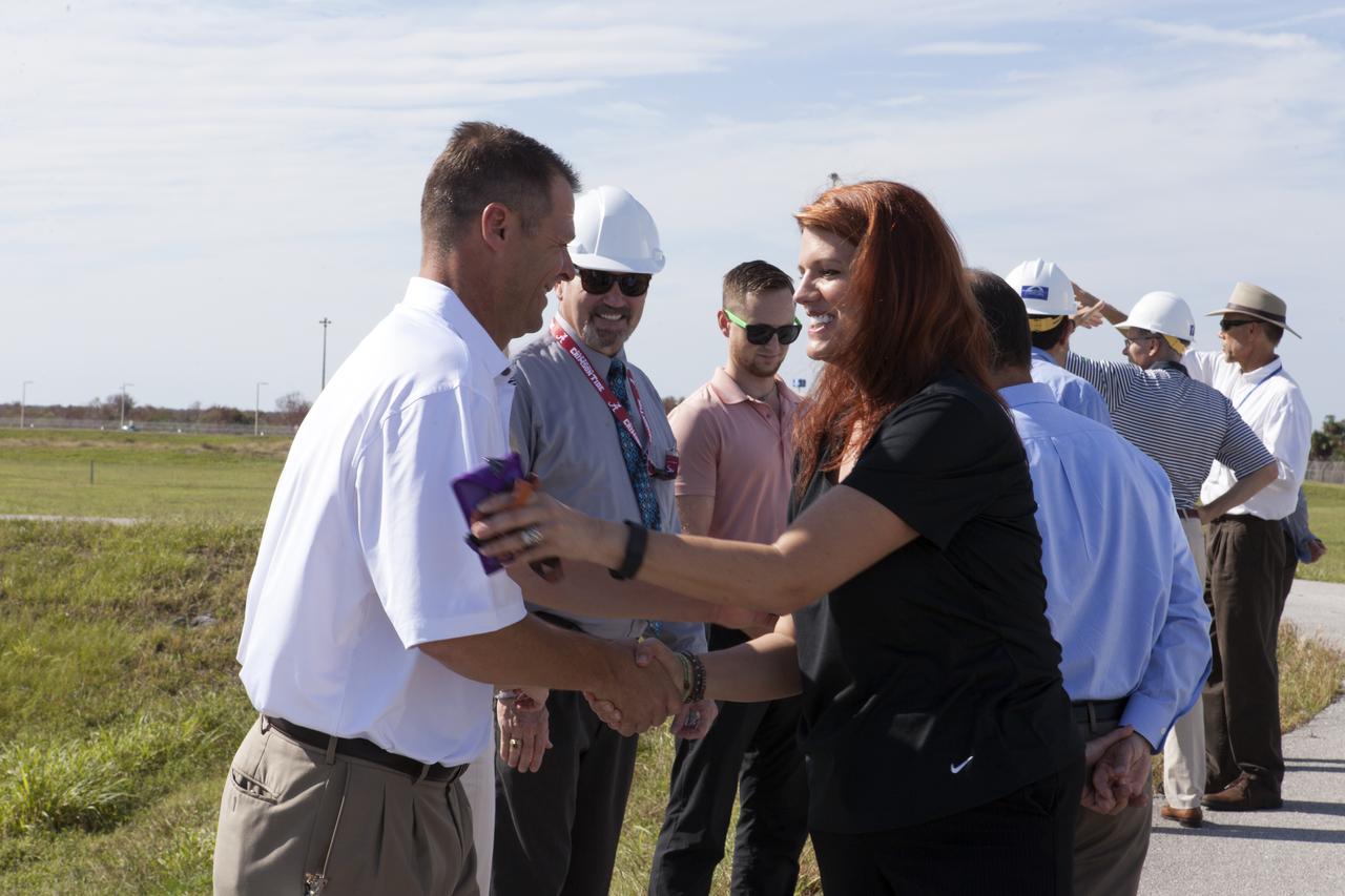 NASA Launch Director Charlie Blackwell-Thompson, at right, greets engineers and technicians at Launch Pad 39B at the agency's Kennedy Space Center in Florida. Blackwell-Thompson will observe the first major tanking operation of liquid oxygen, or LO2, into the giant storage sphere at the northwest corner of the pad to prepare for the launch of the agency's Orion spacecraft atop the Space Launch System (SLS) rocket. During the operation, several Praxair trucks will slowly offload LO2 to gradually chill down the sphere from normal temperature to about negative 298 degrees Fahrenheit. The Ground Systems Development and Operations Program is overseeing upgrades and modifications to pad B to support the launch of the SLS and Orion spacecraft for Exploration Mission-1, deep space missions and NASA’s journey to Mars.