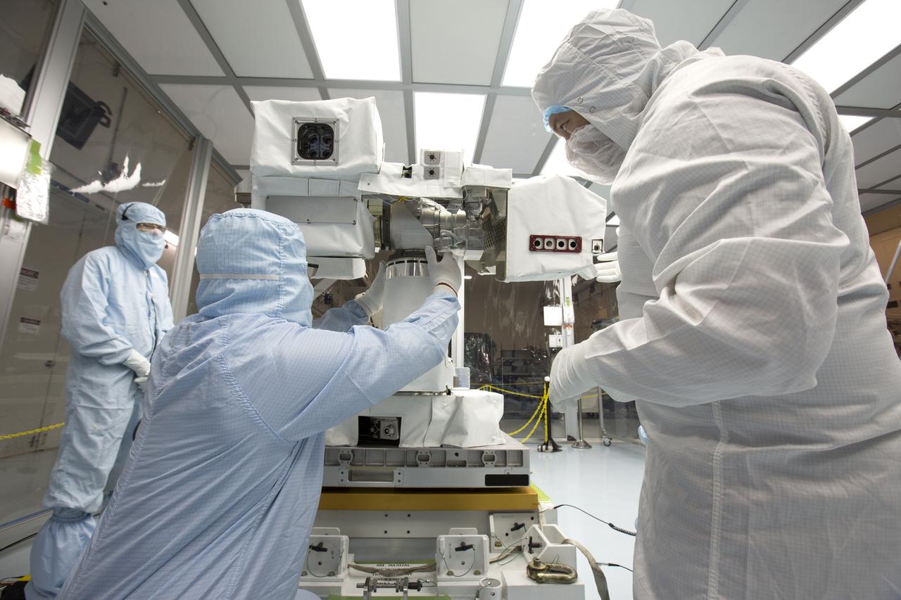 In the high bay of Kennedy Space Center's Space Station Processing Facility, Chris Hardcastle, center, of Stinger-Ghaffarian Technologies performs a sharp edge inspection of the integrated Total and Spectral Solar Irradiance Sensor-1 (TSIS-1) payload and the EXPRESS Pallet Adapter. Hardcastle is joined by Dwayne Swieter, left, and Norm Perish, right, TSIS-1 payload team members from the Laboratory for Atmospheric and Space Physics, a Research Institute at the University of Colorado (Boulder). TSIS-1 is designed to measure the Sun's energy input into Earth by seeing how it is distributed across different wavelengths of light. These measurements help scientists establish Earth's total energy and how our planet's atmosphere responds to changes in the Sun's energy output. TSIS-1 will launch on SpaceX's 13th commercial resupply mission to the International Space Station.