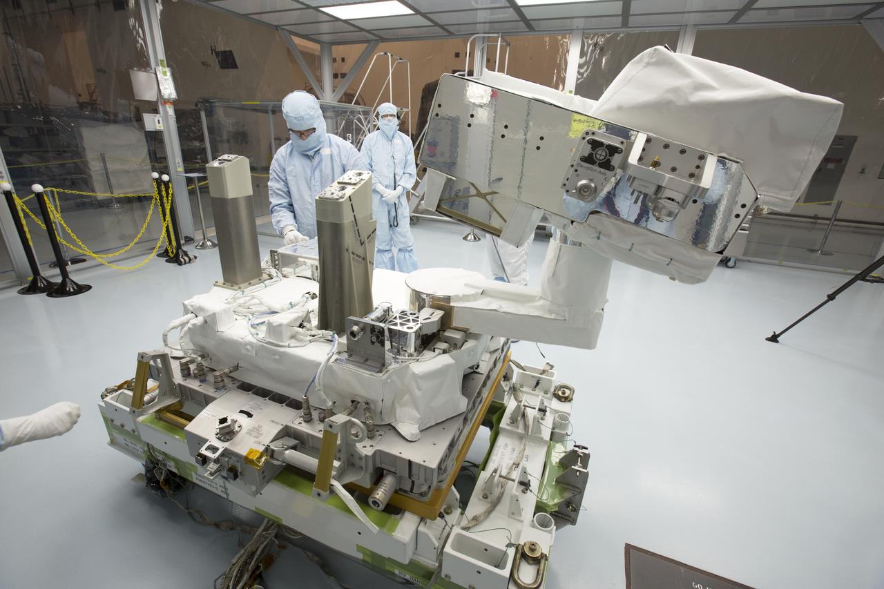In the high bay of Kennedy Space Center's Space Station Processing Facility, Chris Hardcastle, left, of Stinger-Ghaffarian Technologies performs a sharp edge inspection of the integrated Total and Spectral Solar Irradiance Sensor-1 (TSIS-1) payload and the EXPRESS Pallet Adapter. Hardcastle is joined by Dwayne Swieter, right, a TSIS-1 payload team member from the Laboratory for Atmospheric and Space Physics, a Research Institute at the University of Colorado (Boulder). TSIS-1 is designed to measure the Sun's energy input into Earth by seeing how it is distributed across different wavelengths of light. These measurements help scientists establish Earth's total energy and how our planet's atmosphere responds to changes in the Sun's energy output. TSIS-1 will launch on SpaceX's 13th commercial resupply mission to the International Space Station.