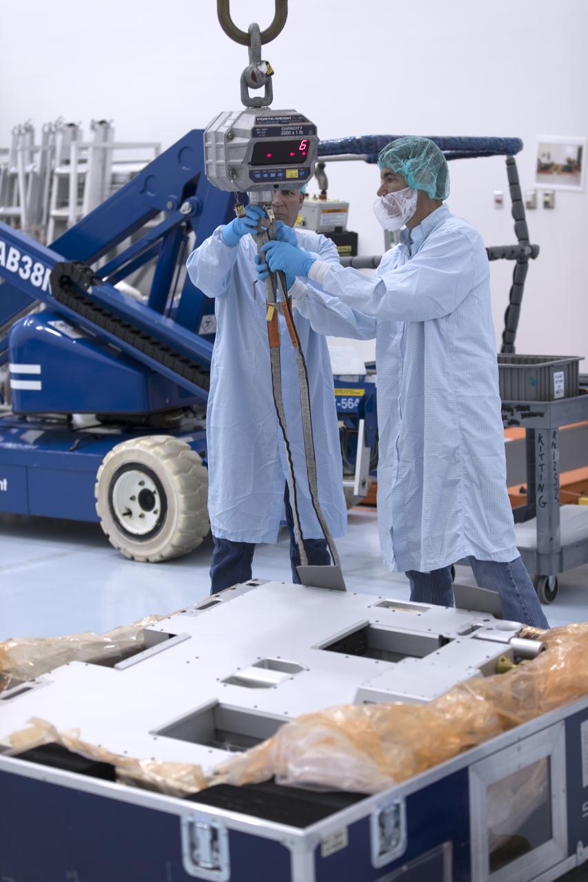 The Materials International Space Station Experiment-Flight Facility, or MISSE-FF, hardware arrived at the Space Station Processing Facility low bay at NASA's Kennedy Space Center in Florida. Technicians work to attach a crane to MISSE for lifting out of its shipping container. MISSE will be used to test various materials and computing elements on the exterior of the space station. They will be exposed to the harsh environment of low-Earth orbit, including to a vacuum, atomic oxygen, ultraviolet radiation, direct sunlight and extreme heat and cold. The experiment will provide a better understanding of material durability, from coatings to electronic sensors, which could be applied to future spacecraft designs. MISSE will be delivered to the space station on a future commercial resupply mission.