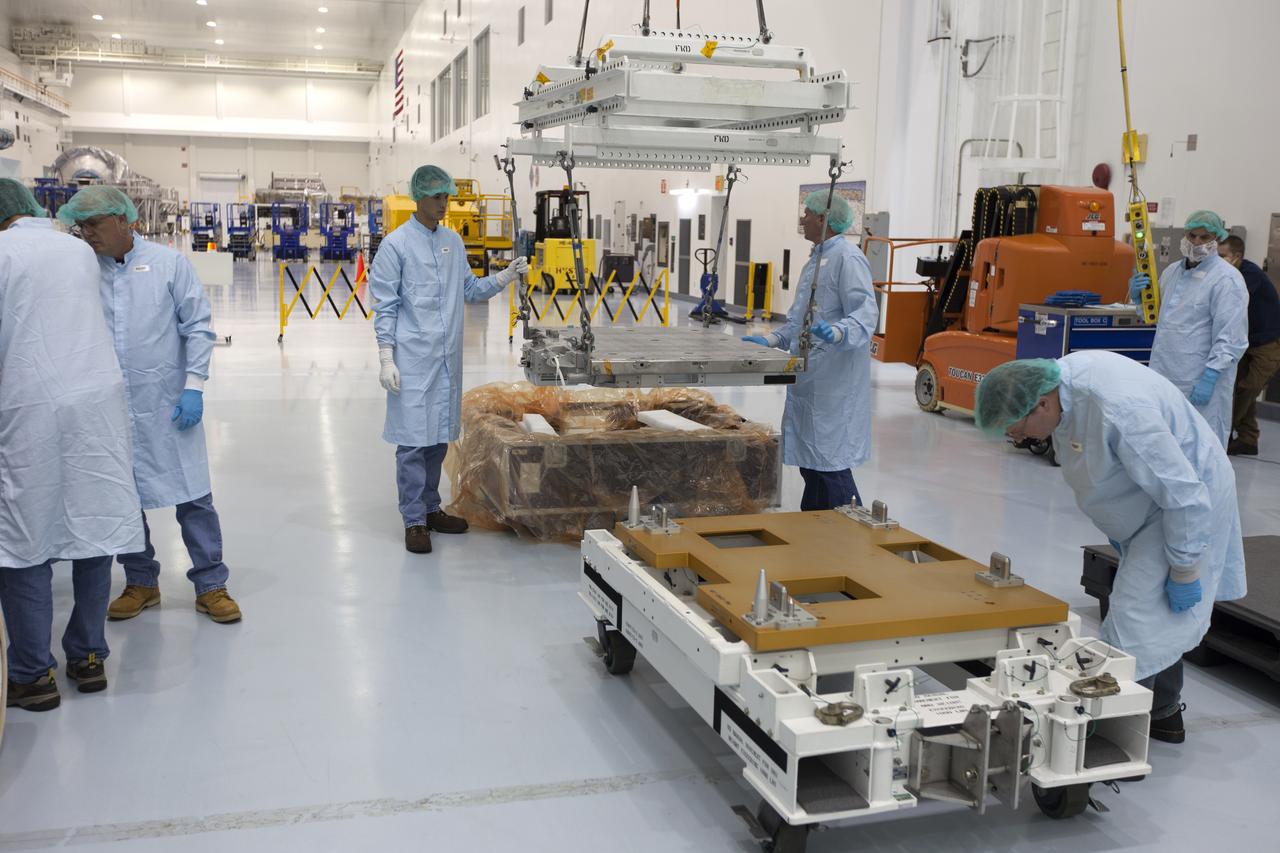 The Materials International Space Station Experiment-Flight Facility, or MISSE-FF, hardware arrived at the Space Station Processing Facility low bay at NASA's Kennedy Space Center in Florida. Technicians assist as MISSE is lifted by crane from its shipping container. MISSE will be used to test various materials and computing elements on the exterior of the space station. They will be exposed to the harsh environment of low-Earth orbit, including to a vacuum, atomic oxygen, ultraviolet radiation, direct sunlight and extreme heat and cold. The experiment will provide a better understanding of material durability, from coatings to electronic sensors, which could be applied to future spacecraft designs. MISSE will be delivered to the space station on a future commercial resupply mission. 