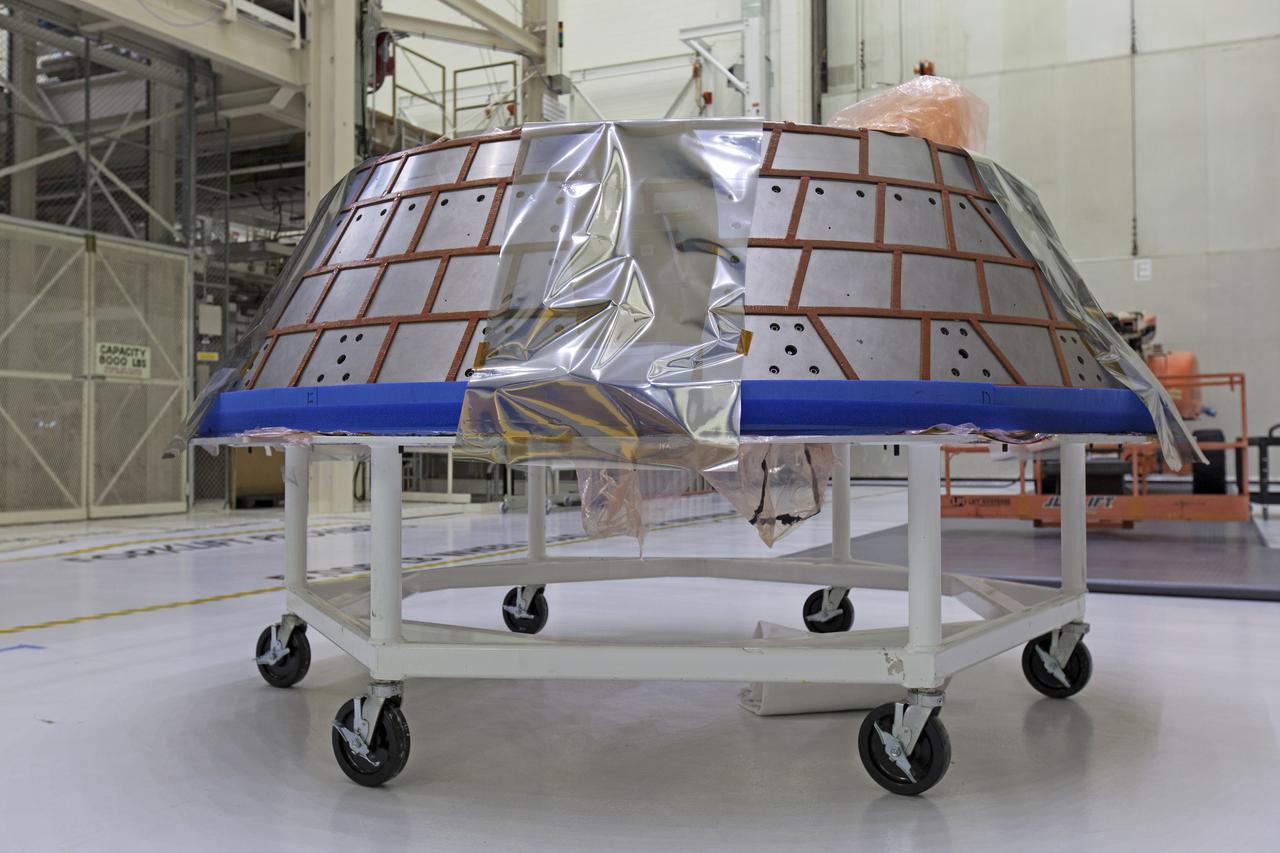 The forward bay cover for the Orion crew module is secured on a movable stand in the Neil Armstrong Operations and Checkout Building high bay at NASA’s Kennedy Space Center in Florida. The space hardware for Orion is undergoing processing to prepare it for launch. Orion is being prepared for its first uncrewed integrated flight atop the Space Launch System rocket on Exploration Mission-1. 