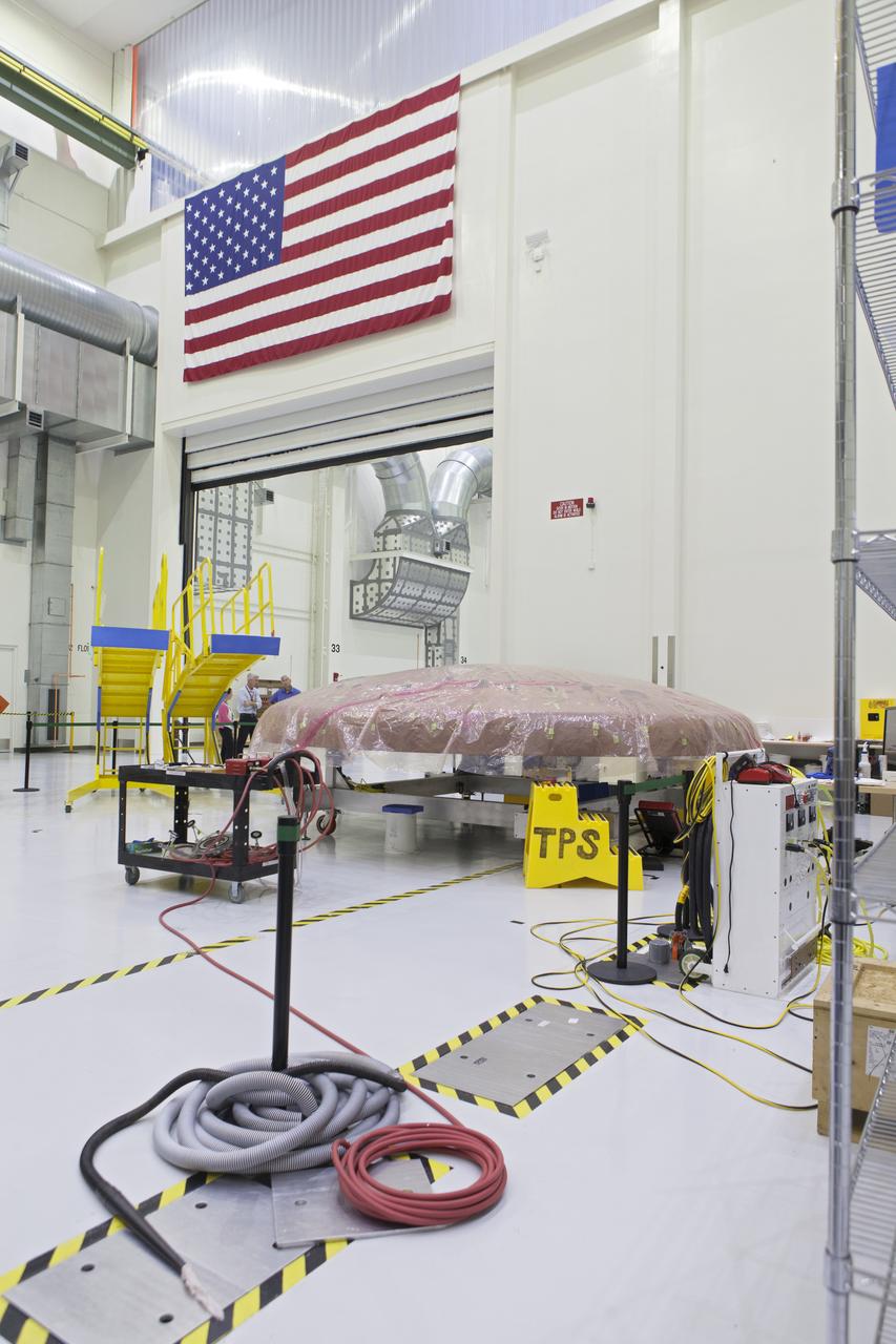 The Orion heat shield is undergoing processing in the Neil Armstrong Operations and Checkout Building high bay at NASA's Kennedy Space Center in Florida.  Orion is being prepared for its first uncrewed integrated flight atop the Space Launch System rocket on Exploration Mission-1.