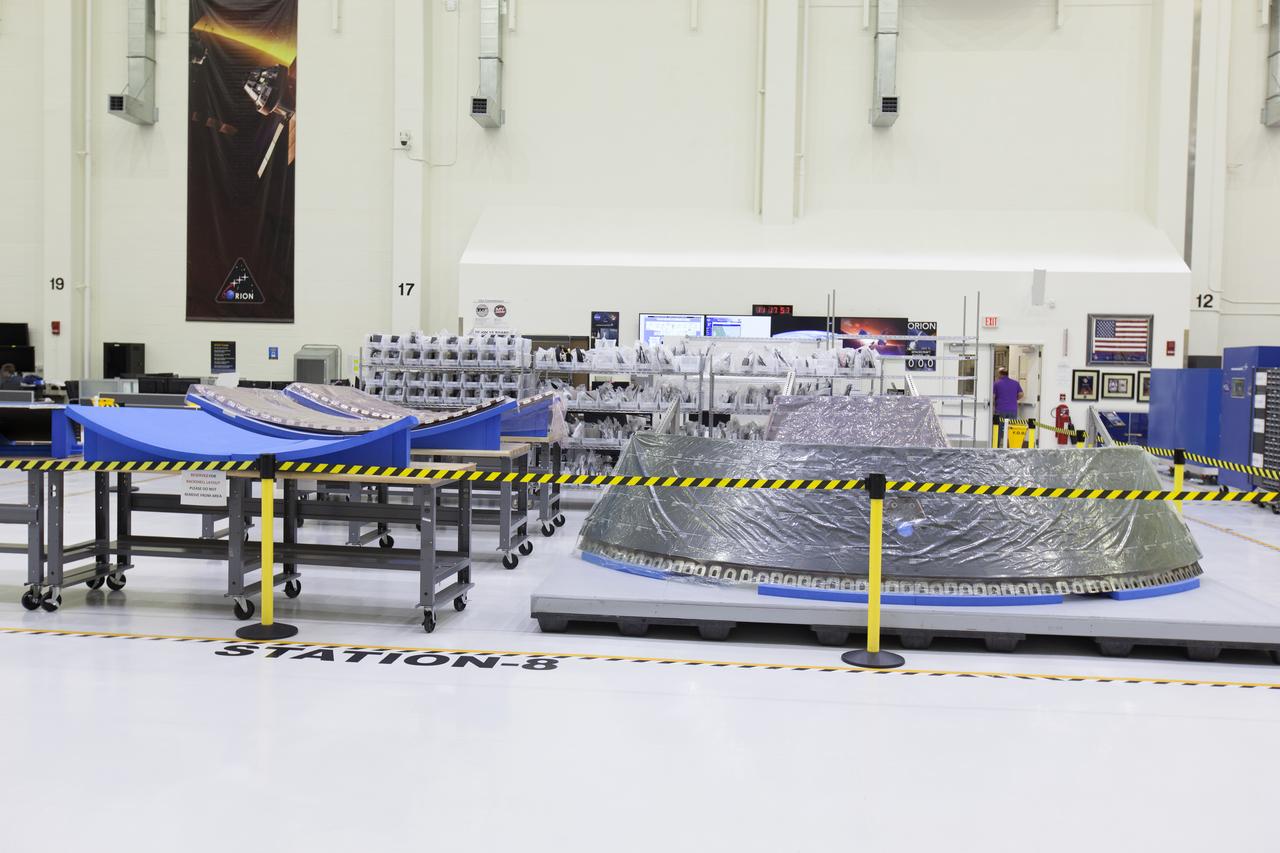 Thermal protection system panels are in view in the high bay of the Neil Armstrong Operations and Checkout Building at NASA's Kennedy Space Center in Florida. The Orion crew module for NASA’s Exploration Mission 1 (EM-1) is being prepared for its first integrated flight atop the Space Launch System rocket. 