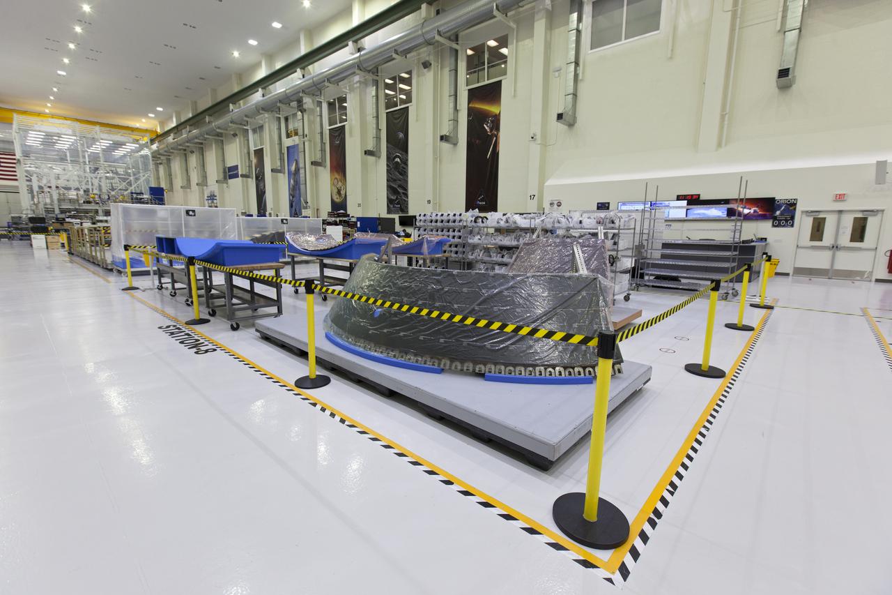 Thermal protection system panels are in view in the high bay of the Neil Armstrong Operations and Checkout Building at NASA's Kennedy Space Center in Florida. The Orion crew module for NASA’s Exploration Mission 1 (EM-1) is being prepared for its first integrated flight atop the Space Launch System rocket. 