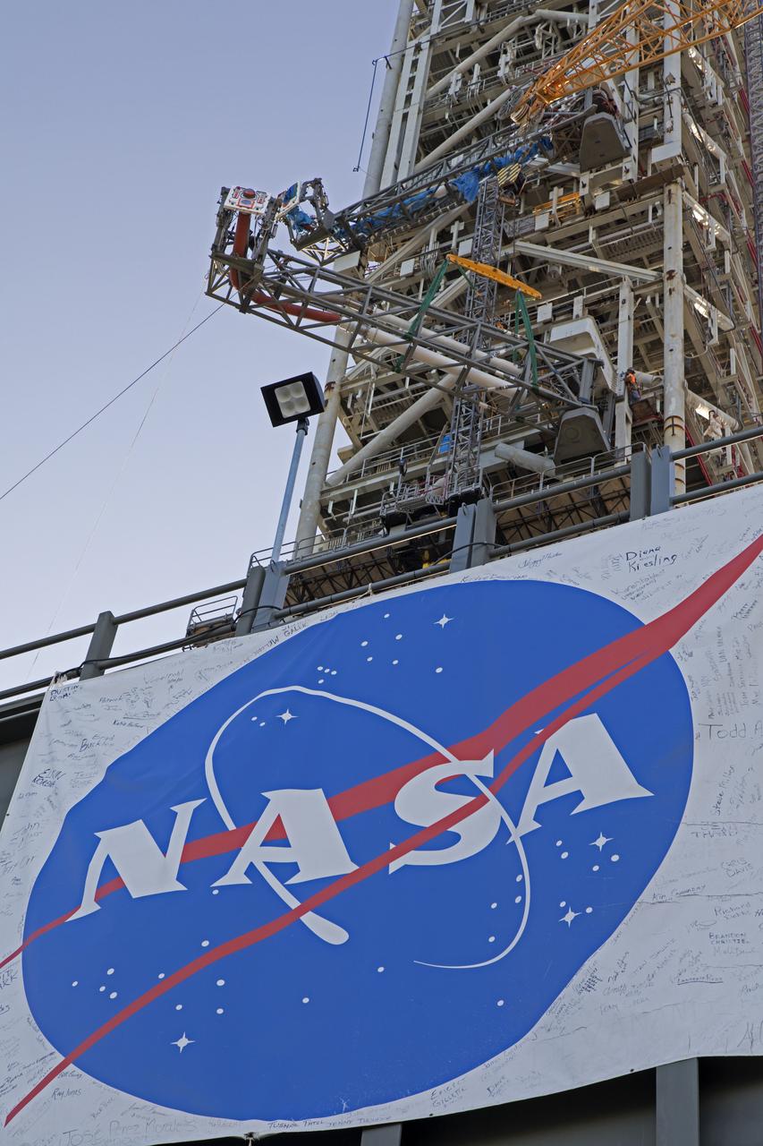 A heavy-lift crane moves the Core Stage Inter-tank Umbilical (CSITU) up to about the 140-foot level of the mobile launcher (ML) tower at NASA's Kennedy Space Center in Florida. The CSITU is moved into place for a fit check of the attachment hardware. The umbilical will be lowered down and installed permanently on the ML at a later date. The CSITU is a swing-arm umbilical that will connect to the Space Launch System core stage inter-tank. It will provide conditioned air, pressurized gases and power and data connection to the core stage. The Ground Systems Development and Operations Program is overseeing installation of the umbilicals. 