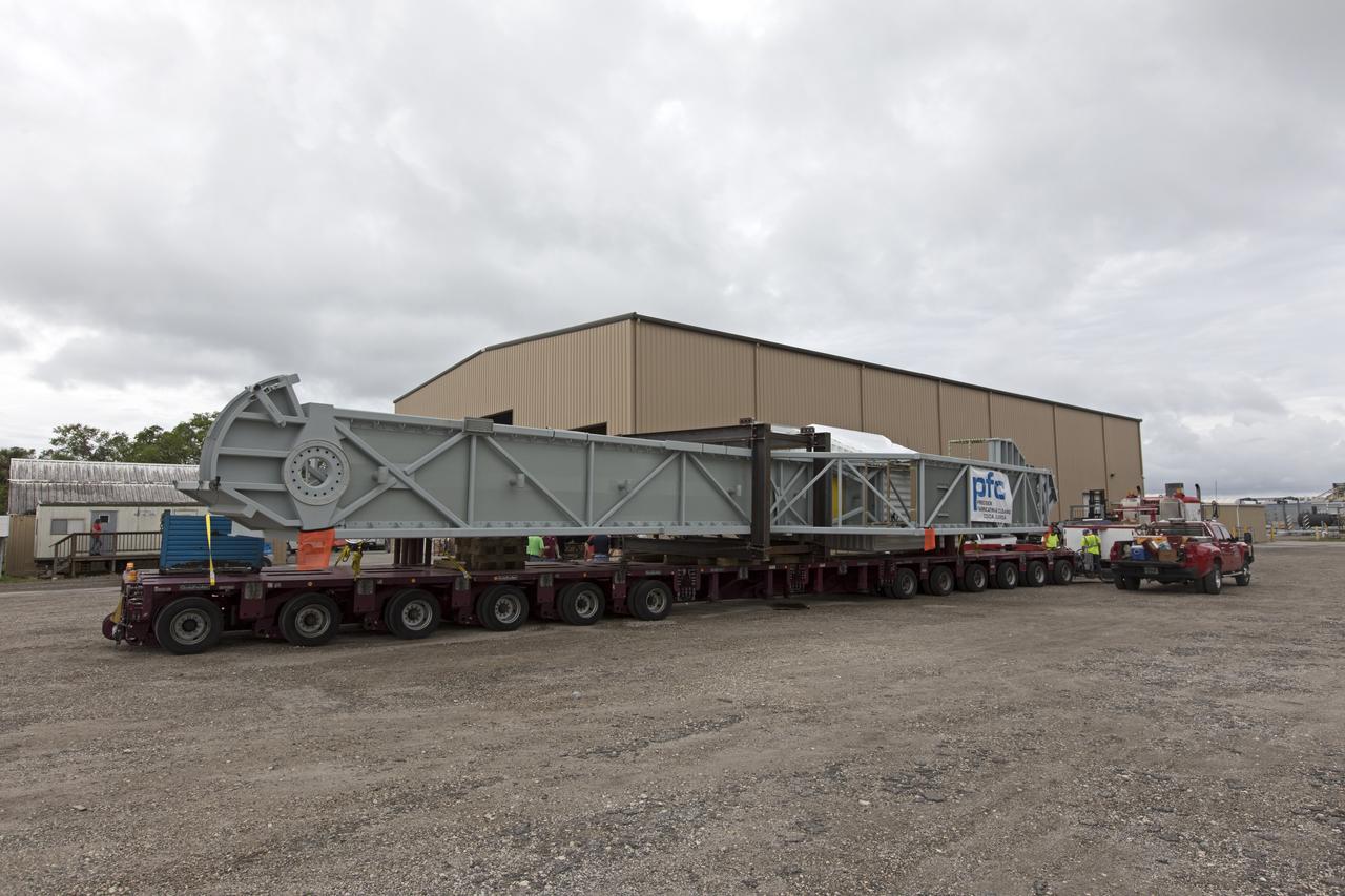 The Orion crew access arm is secured on a flatbed truck at Precision Fabricating and Cleaning in Cocoa, Florida and ready to be transported to a storage location at NASA's Kennedy Space Center in Florida. Later this month, the arm will be transported to the mobile launcher (ML) tower at the center. The crew access arm will be located at about the 274-foot level on the tower. It will rotate from its retracted position and interface with the Orion crew hatch location to provide entry to the Orion crew module. The Ground Systems Development and Operations Program is overseeing installation of umbilicals and launch accessories on the ML tower. 