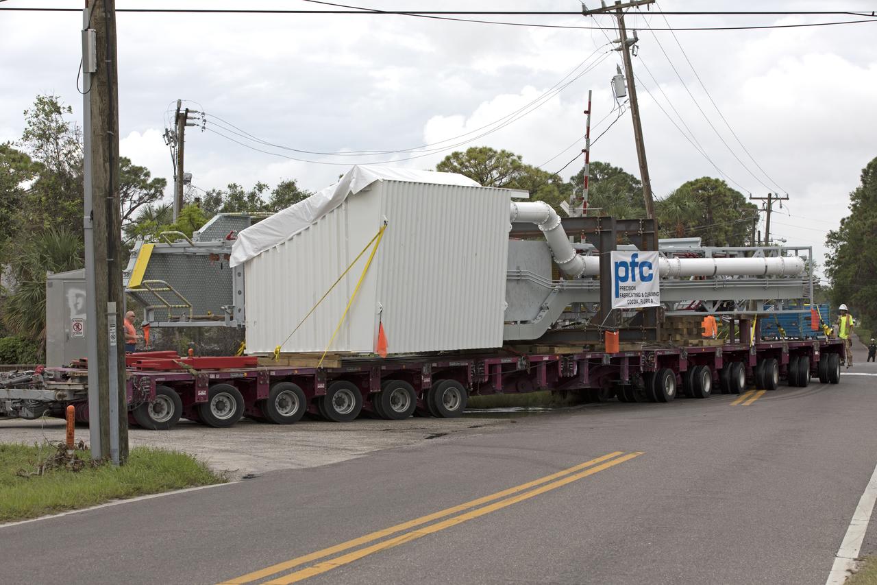 The Orion crew access arm departs Precision Fabricating and Cleaning in Cocoa, Florida, atop a flatbed truck. The access arm will be transported to a storage location at NASA's Kennedy Space Center in Florida. Later this month, the arm will be transported to the mobile launcher (ML) tower at the center. The crew access arm will be located at about the 274-foot level on the tower. It will rotate from its retracted position and interface with the Orion crew hatch location to provide entry to the Orion crew module. The Ground Systems Development and Operations Program is overseeing installation of umbilicals and launch accessories on the ML tower.