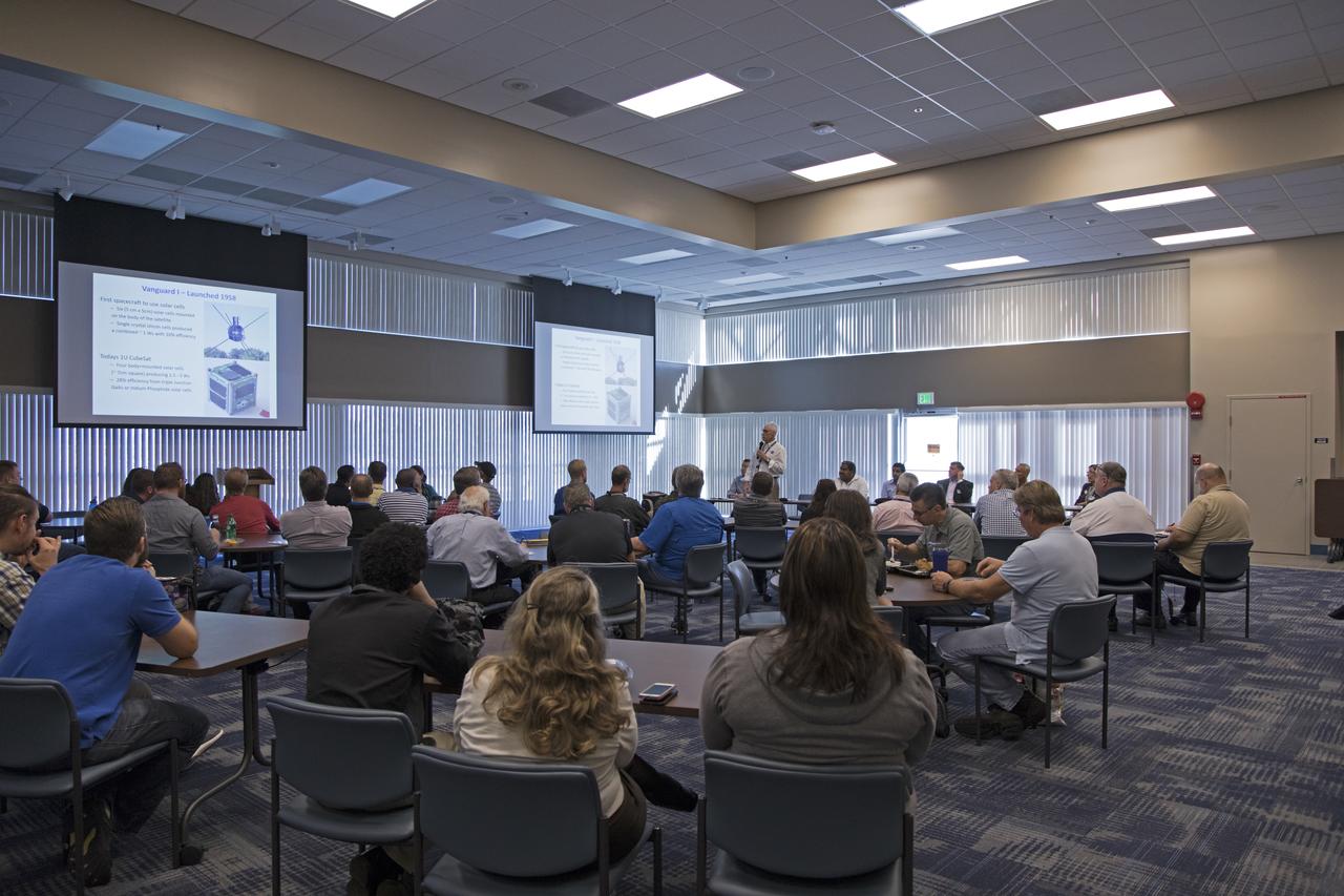 Chuck Tatro of NASA's Launch Services Program discusses the use of solar arrays on space science missions during the Energy Action Day employee event held in Kennedy Space Center's Space Station Processing Facility. Part of Energy Awareness Month, the event featured subject matter experts in the area of solar energy, its connections to the space program and options for residential solar power.