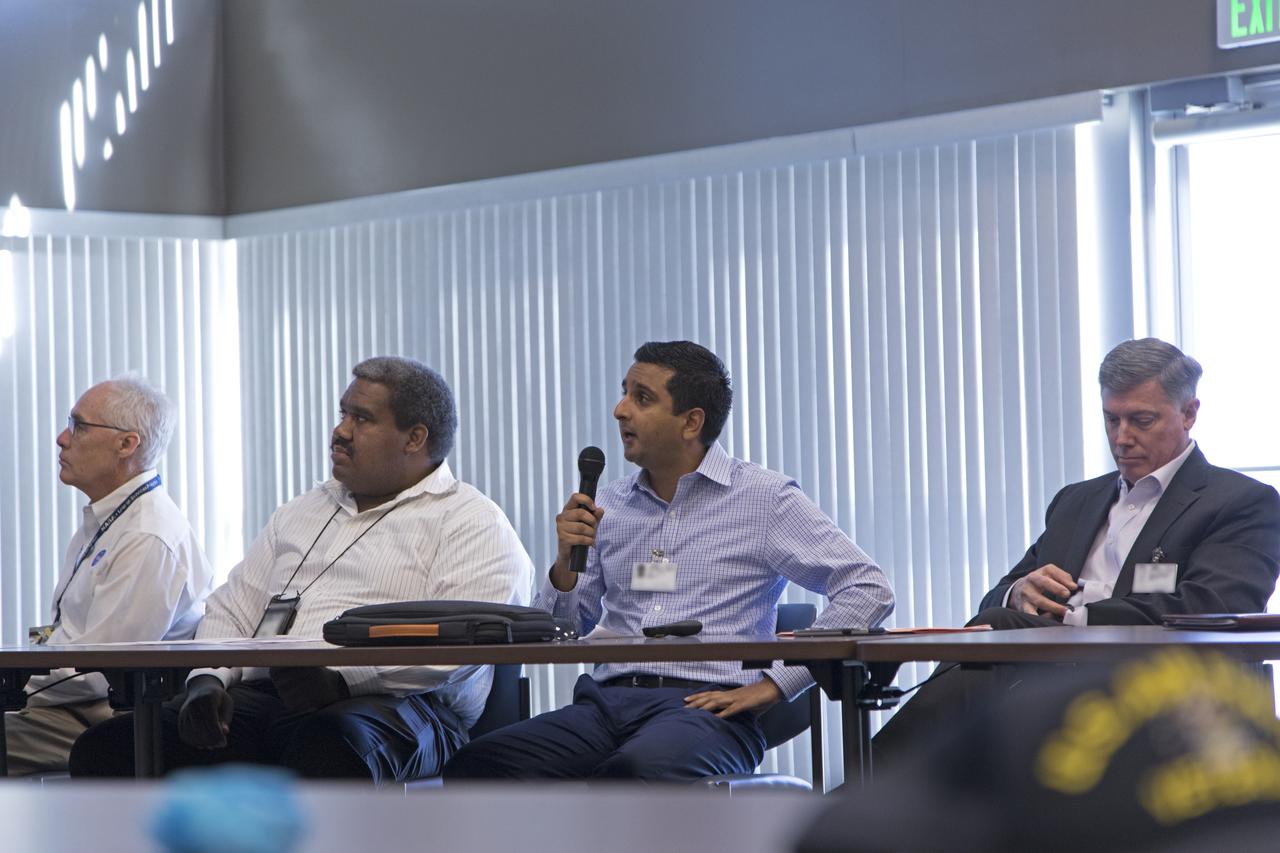 Anuj Chokshi of FPL, center, speaks during the Energy Action Day employee event held in NASA Kennedy Space Center's Space Station Processing Facility. Part of Energy Awareness Month, the event featured subject matter experts in the area of solar energy, its connections to the space program and options for residential solar power. From left to right are Chuck Tatro of NASA's Launch Services Program; Sam Ball of NASA Kennedy's Engineering directorate; Chokshi; and Bill McMullen of Southern Power.