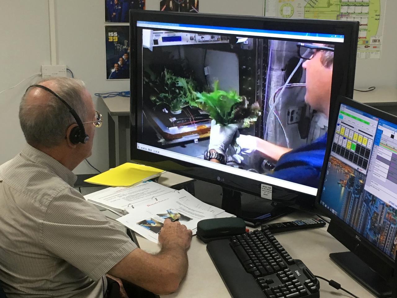 Charles Spern, project manager on the Engineering Services Contract, communicates instructions for the Veggie system to astronaut Joe Acaba on the International Space Station. Spern is in the Experiment Monitoring Room in the Space Station Processing Facility at Kennedy Space Center in Florida. Three different varieties of plants from the Veg-03D plant experiment were harvested.