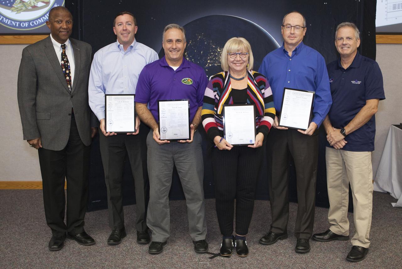 U.S. Patent plaques were awarded to, second from left, Luke Roberson, Trent Smith, Martha Williams and James Fesmire, for their invention, Aerogel/Polymer Composite Materials, known as Aeroplastic, during the 2017 Innovation Expo at NASA's Kennedy Space Center in Florida. At left is Kelvin Manning, Kennedy's associate director; and at far right is Dave Makufka, Kennedy's Technology Transfer Program manager. The purpose of the annual two-day expo is to help foster innovation and creativity among the Kennedy workforce. The event included several keynote speakers, training opportunities, an innovation showcase and the KSC Kickstart competition. 