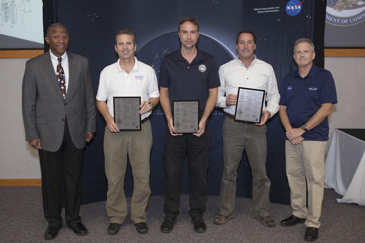 U.S. Patent plaques were awarded to, second from left, Robert Mueller, Adam Dokos and Ivan Townsend III, for their invention, Self-Cleaning Filament Connector, during the 2017 Innovation Expo at NASA's Kennedy Space Center in Florida. At left is Kelvin Manning, Kennedy's associate director. At far right is Dave Makufka, Kennedy's Technology Transfer Program manager. The purpose of the annual two-day expo is to help foster innovation and creativity among the Kennedy workforce. The event included several keynote speakers, training opportunities, an innovation showcase and the KSC Kickstart competition. 
