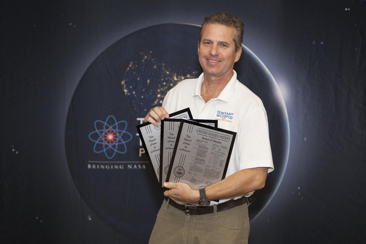 Robert Mueller displays the three U.S. Patent plaques he received during a ceremony at the 2017 Innovation Expo at NASA's Kennedy Space Center in Florida. The purpose of the annual two-day expo is to help foster innovation and creativity among the Kennedy workforce. The event included several keynote speakers, training opportunities, an innovation showcase and the KSC Kickstart competition. 