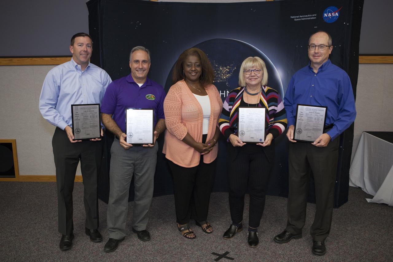NASA Kennedy Space Center workers display their U.S. Patent plaques during a ceremony at the 2017 Innovation Expo at the center. From left, are Luke Robertson, Trent Smith, Kelly Jones-McDowall, event co-chairperson, Martha Williams and Dr. James Fesmire. The purpose of the annual two-day expo is to help foster innovation and creativity among the Kennedy workforce. The event included several keynote speakers, training opportunities, an innovation showcase and the KSC Kickstart competition. 