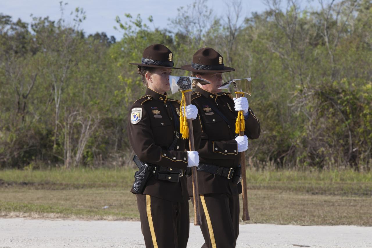 Firefighters prepare to place ceremonial Pulaski tools by a new memorial marker Nov. 1 on the Merritt Island National Wildlife Refuge in Florida. During a joint ceremony, the Spaceport Integration Team and its partners were presented with the prestigious 2017 Pulaski Award and the new memorial marker was dedicated. The multi-agency team includes representatives from NASA's Kennedy Space Center, Cape Canaveral Air Force Station's 45th Space Wing, the Merritt Island National Wildlife Refuge, as well as the Florida Forest Service and Brevard County Fire Rescue. The memorial marker honors two fallen firefighters, Scott Maness and Beau Sauselein, who died fighting a wildfire on space center property in 1981. Held outdoors, the ceremony was attended by 140 guests.