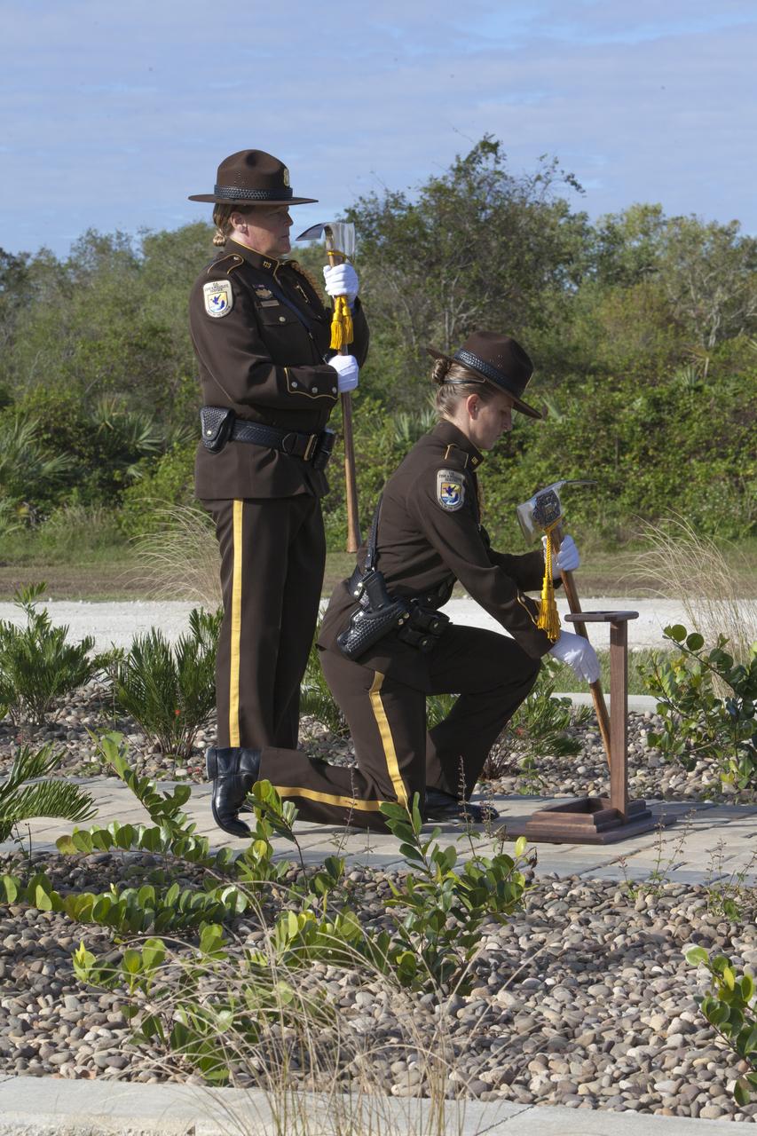 Firefighters place ceremonial Pulaski tools by a new memorial marker Nov. 1 on the Merritt Island National Wildlife Refuge in Florida. During a joint ceremony, the Spaceport Integration Team and its partners were presented with the prestigious 2017 Pulaski Award and the new memorial marker was dedicated. The multi-agency team includes representatives from NASA's Kennedy Space Center, Cape Canaveral Air Force Station's 45th Space Wing, the Merritt Island National Wildlife Refuge, as well as the Florida Forest Service and Brevard County Fire Rescue. The memorial marker honors two fallen firefighters, Scott Maness and Beau Sauselein, who died fighting a wildfire on space center property in 1981. Held outdoors, the ceremony was attended by 140 guests.