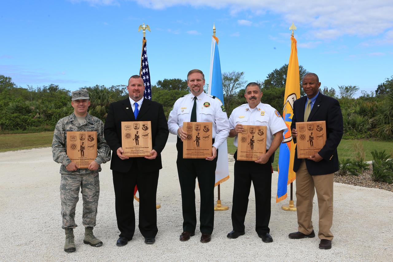From left, Col. Z. Walter Jackim, vice commander, 45th Space Wing, Cape Canaveral Air Force Station; Michael Good, assistant fire management officer, Merritt Island National Wildlife Refuge; John Fish, chief, Florida Forest Service; Mark Schollmeyer, chief, Brevard County Fire Rescue; and Kelvin Manning, associate director, NASA's Kennedy Space Center, pose for a portrait following a ceremony Nov. 1 on the Merritt Island National Wildlife Refuge in Florida. During the joint ceremony, the Spaceport Integration Team and its partners were presented with the prestigious 2017 Pulaski Award and a new memorial marker was dedicated. The multi-agency team includes representatives from NASA's Kennedy Space Center, Cape Canaveral Air Force Station's 45th Space Wing, the Merritt Island National Wildlife Refuge, as well as the Florida Forest Service and Brevard County Fire Rescue. The memorial marker honors two fallen firefighters, Scott Maness and Beau Sauselein, who died fighting a wildfire on space center property in 1981. Held outdoors, the ceremony was attended by 140 guests.