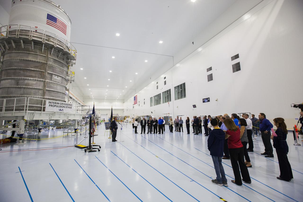 In the Space Station Processing Facility at NASA's Kennedy Space Center in Florida, a ceremony is underway marking the agency's Spacecraft/Payload Integration and Evolution (SPIE) organization formally turning over processing of the Space Launch System (SLS) rocket's Interim Cryogenic Propulsion Stage (ICPS), to the center's Ground Systems Development and Operations (GSDO) Directorate. The ICPS is seen on the left in its shipping container and is the first integrated piece of flight hardware to arrive in preparation for the uncrewed Exploration Mission-1. With the Orion attached, the ICPS sits atop the SLS rocket and will provide the spacecraft with the additional thrust needed to travel tens of thousands of miles beyond the Moon.