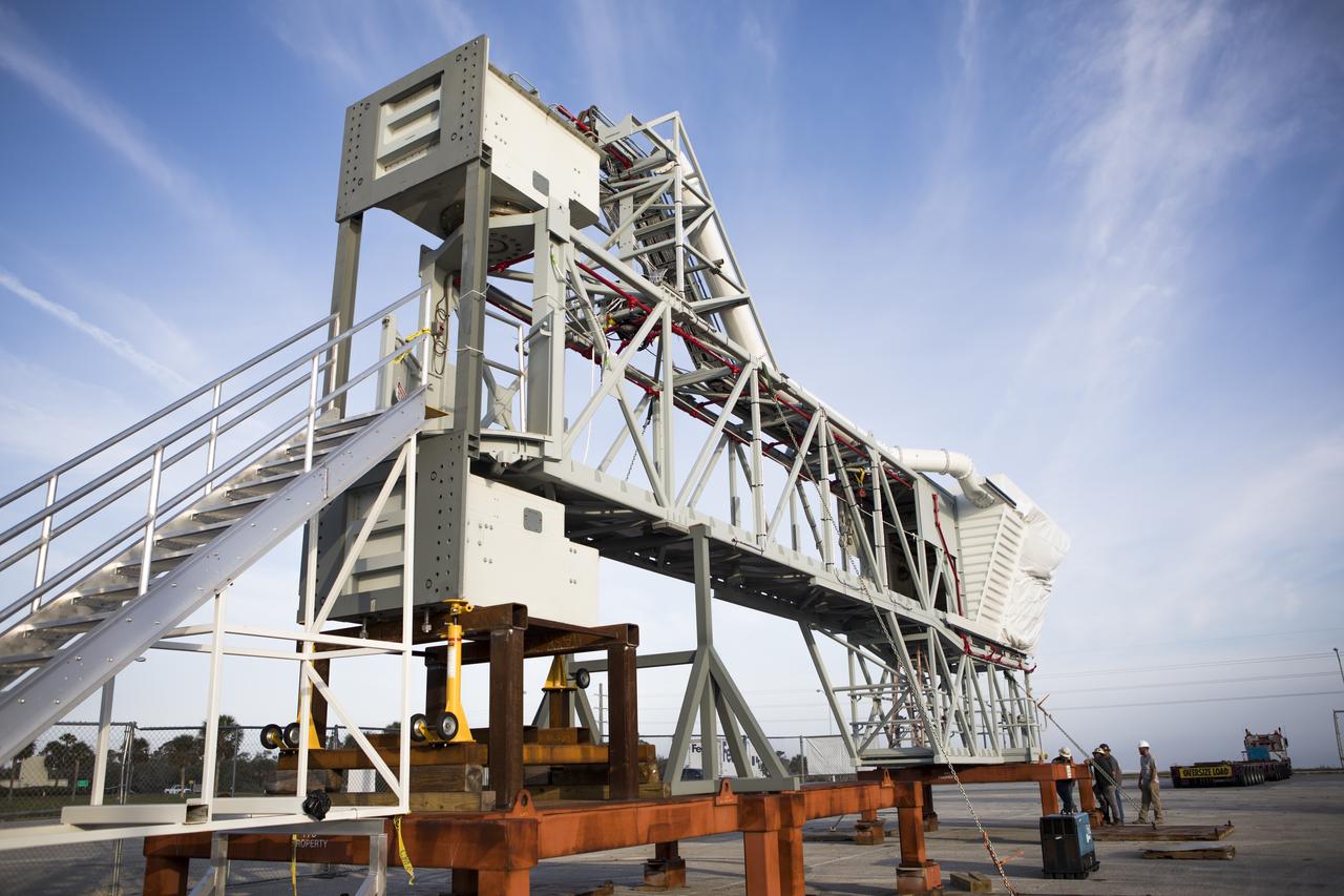 The Orion crew access arm, secured on a stand, is being prepared for its move from a storage location at NASA's Kennedy Space Center in Florida, to the mobile launcher (ML) tower near the Vehicle Assembly Building at the center. The crew access arm will be installed at about the 274-foot level on the tower. It will rotate from its retracted position and interface with the Orion crew hatch location to provide entry to the Orion crew module. The Ground Systems Development and Operations Program is overseeing installation of umbilicals and launch accessories on the ML tower. 
