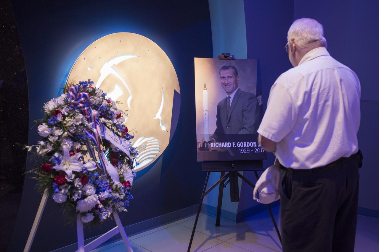 In the Heroes and Legends exhibit at the Kennedy Space Center Visitor Complex, a guest pays respect to former NASA astronaut Richard Gordon. A memorial wreath was placed following a ceremony to honor the memory of Gordon who performed two spacewalks during Gemini XI in 1966 and served as command module pilot on Apollo 12 in 1969. Gordon died Nov. 6, 2017, at the age of 88.