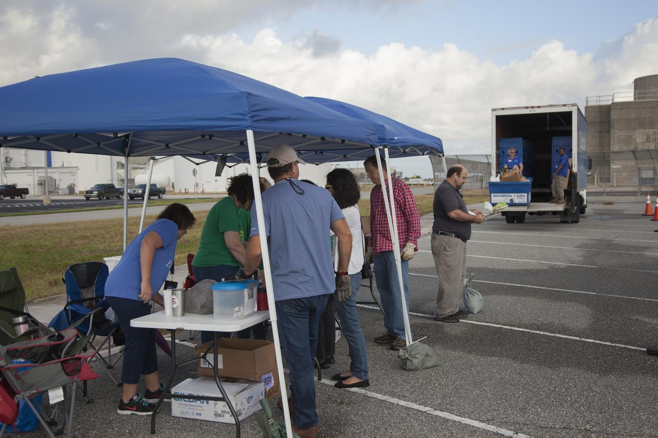 In the parking lot of the Vehicle Assembly Building at NASA's Kennedy Space Center in Florida, employees drop off used household items as part of America Recycles Day. The center recently partnered with Goodwill Industries and several other local organizations to collect items for reprocessing. The annual event is a program of Keep America Beautiful, dedicated to promoting and celebrating recycling.