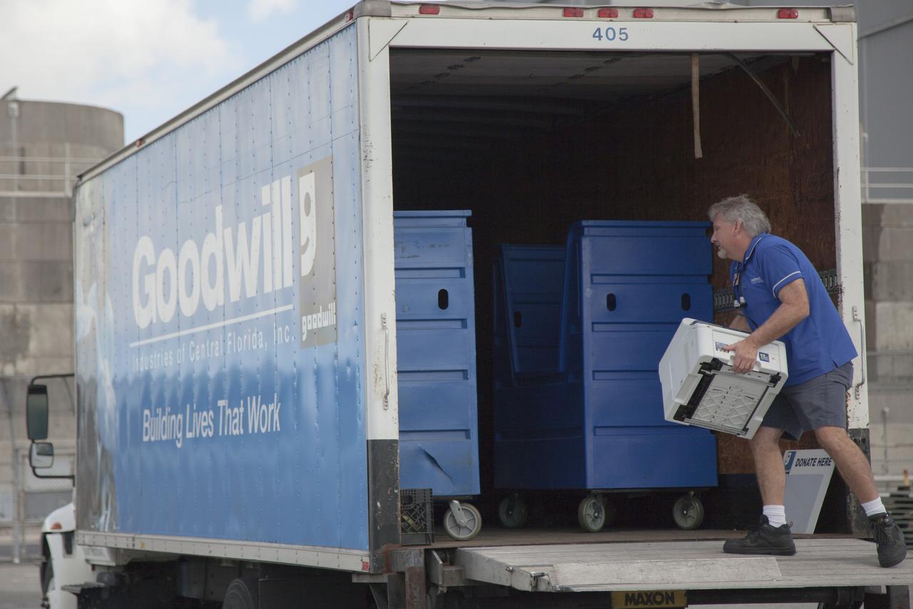 In the parking lot of the Vehicle Assembly Building at NASA's Kennedy Space Center in Florida, a member of Goodwill Industries loads used household material for recycling. During the two-day event, employees dropped off items as part of America Recycles Day. The center partnered with Goodwill Industries and several other local organizations to collect items for reprocessing. The annual event is a program of Keep America Beautiful, dedicated to promoting and celebrating recycling.